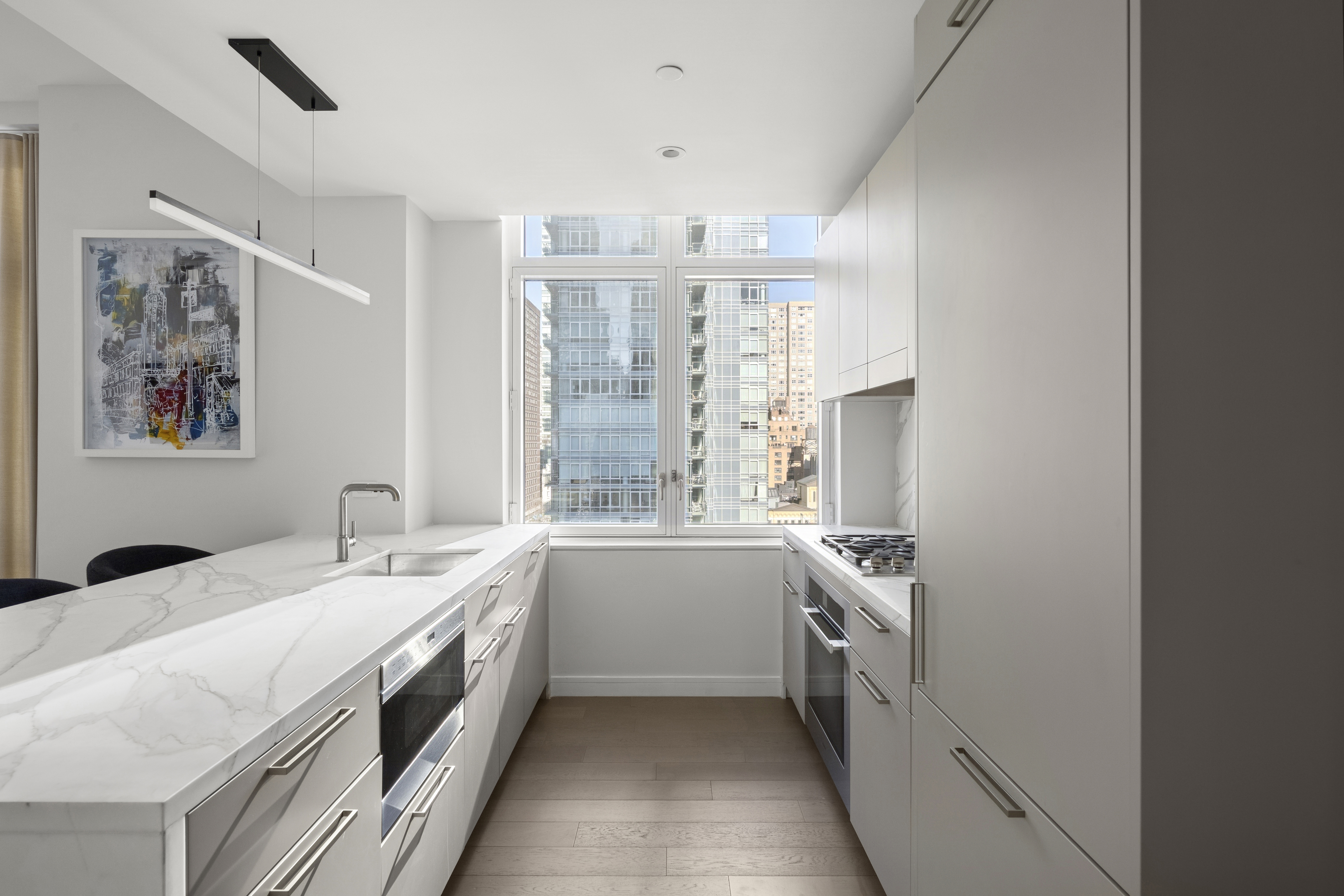 305 East 51st Street, Unit 11D Manhattan, NY 10022 - Photo 6 of 18 a kitchen with a sink and stove