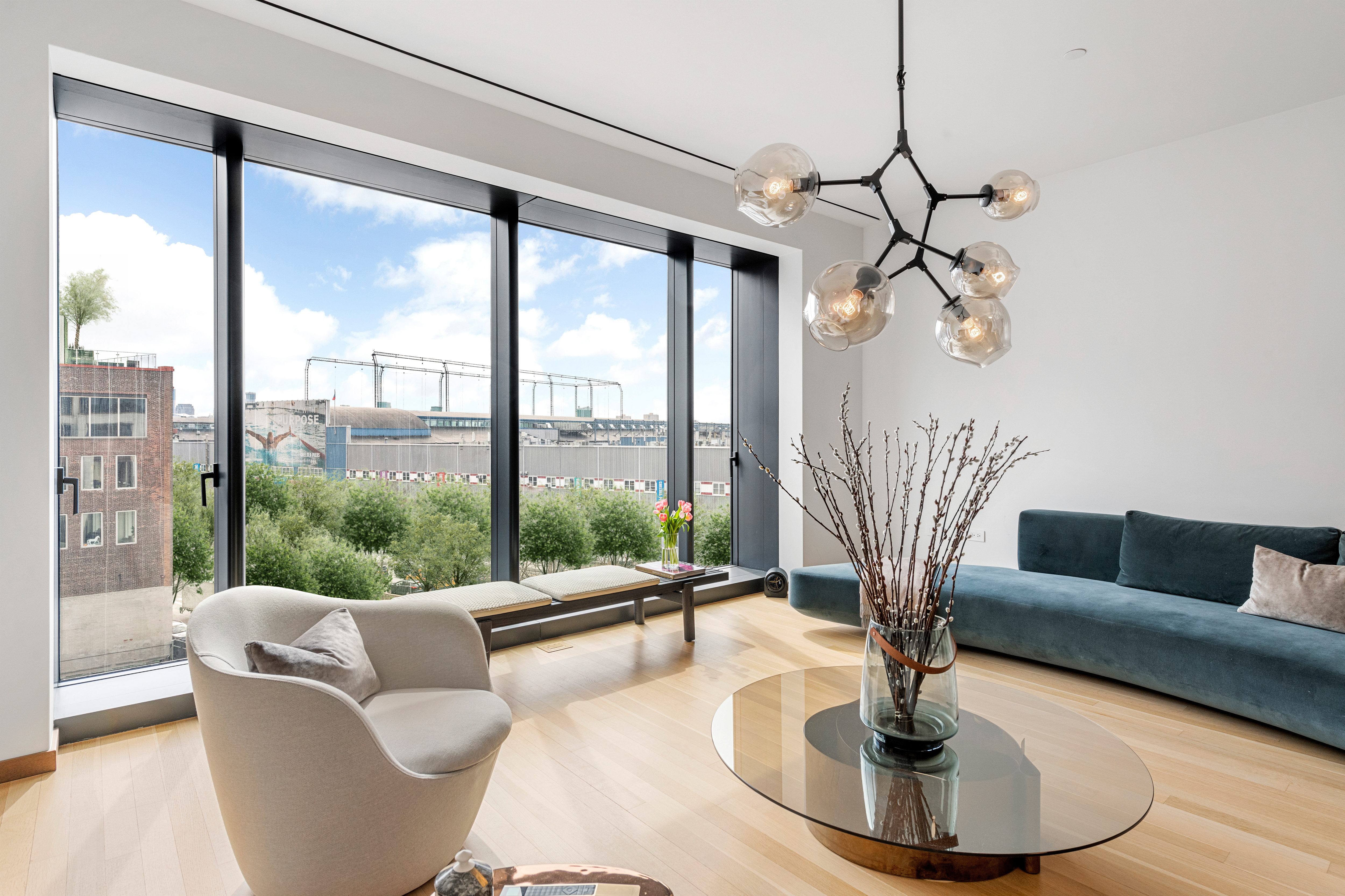 551 West 21st Street, Unit 4D Manhattan, NY 10011 - Photo 2 of 16 a living room with couch and a large window
