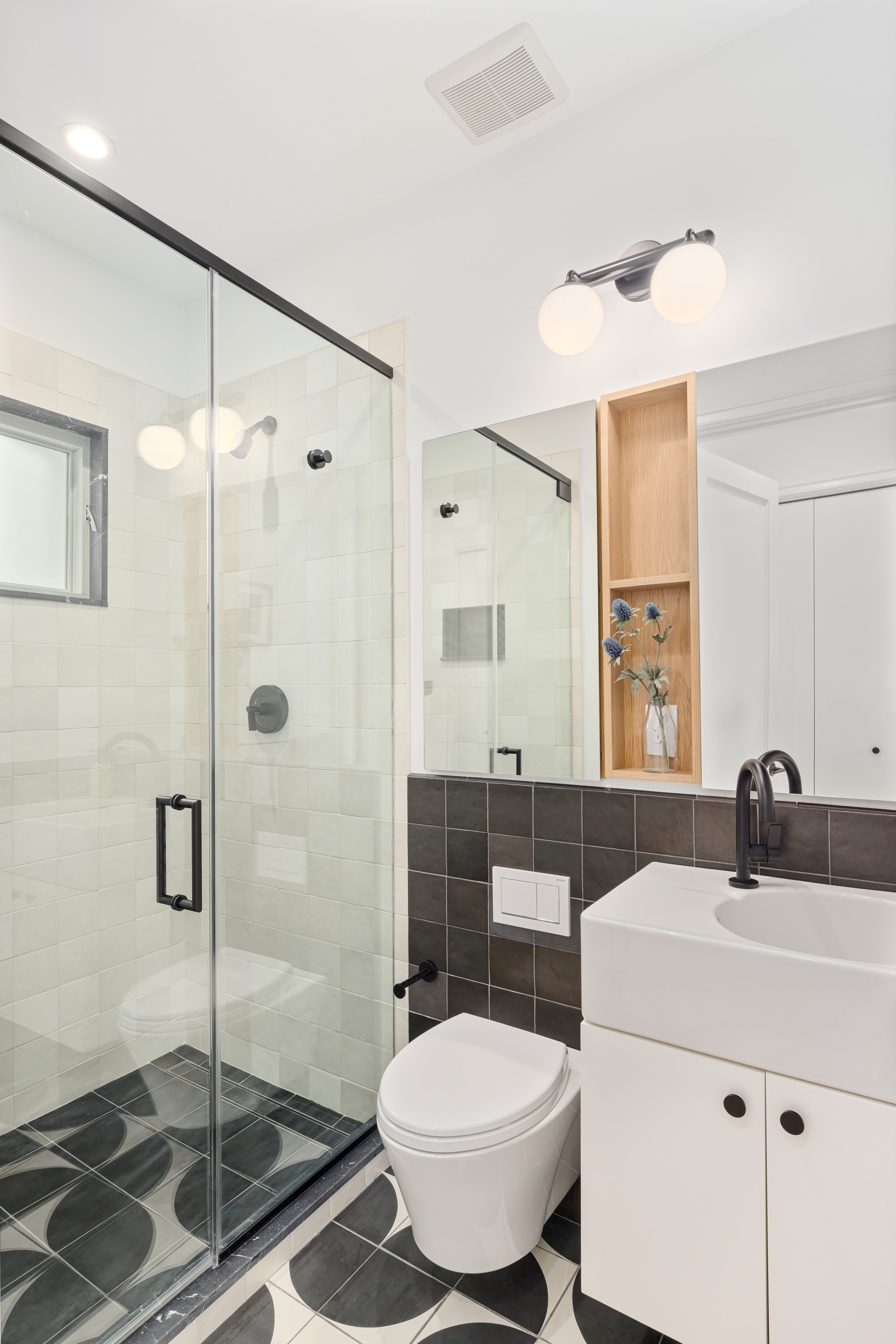 179 Devoe Street Brooklyn, NY 11211 - Photo 15 of 20 a bathroom with a sink toilet a mirror and shower
