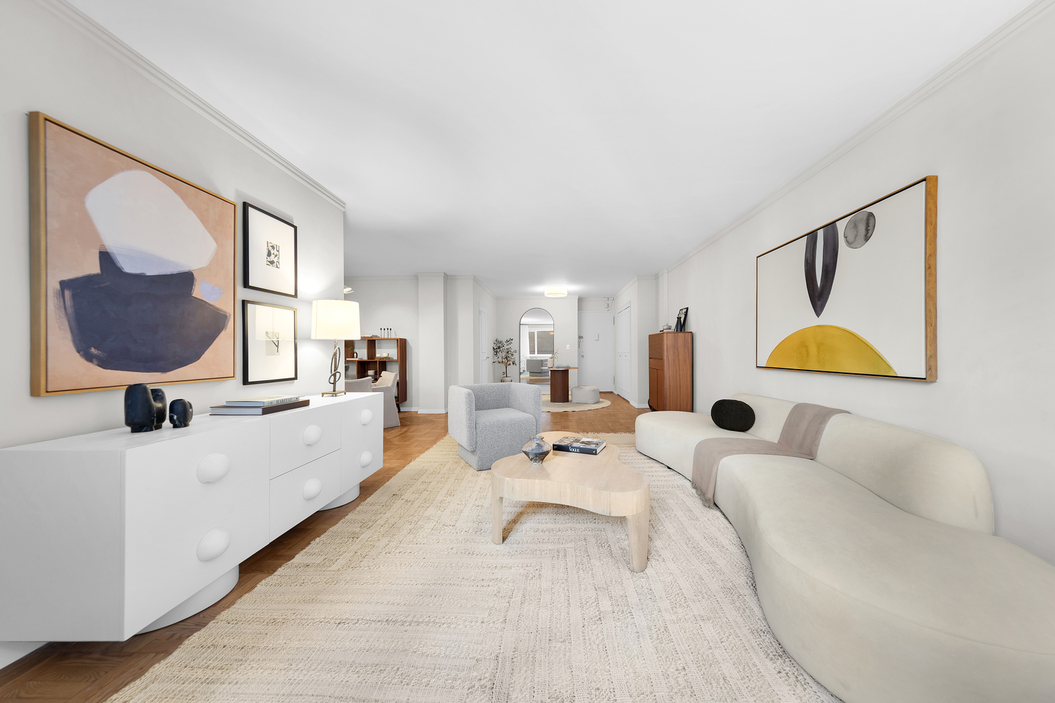 411 East 53rd Street, Unit 8C Manhattan, NY 10022 - Photo 2 of 10 a living room with furniture and a lamp