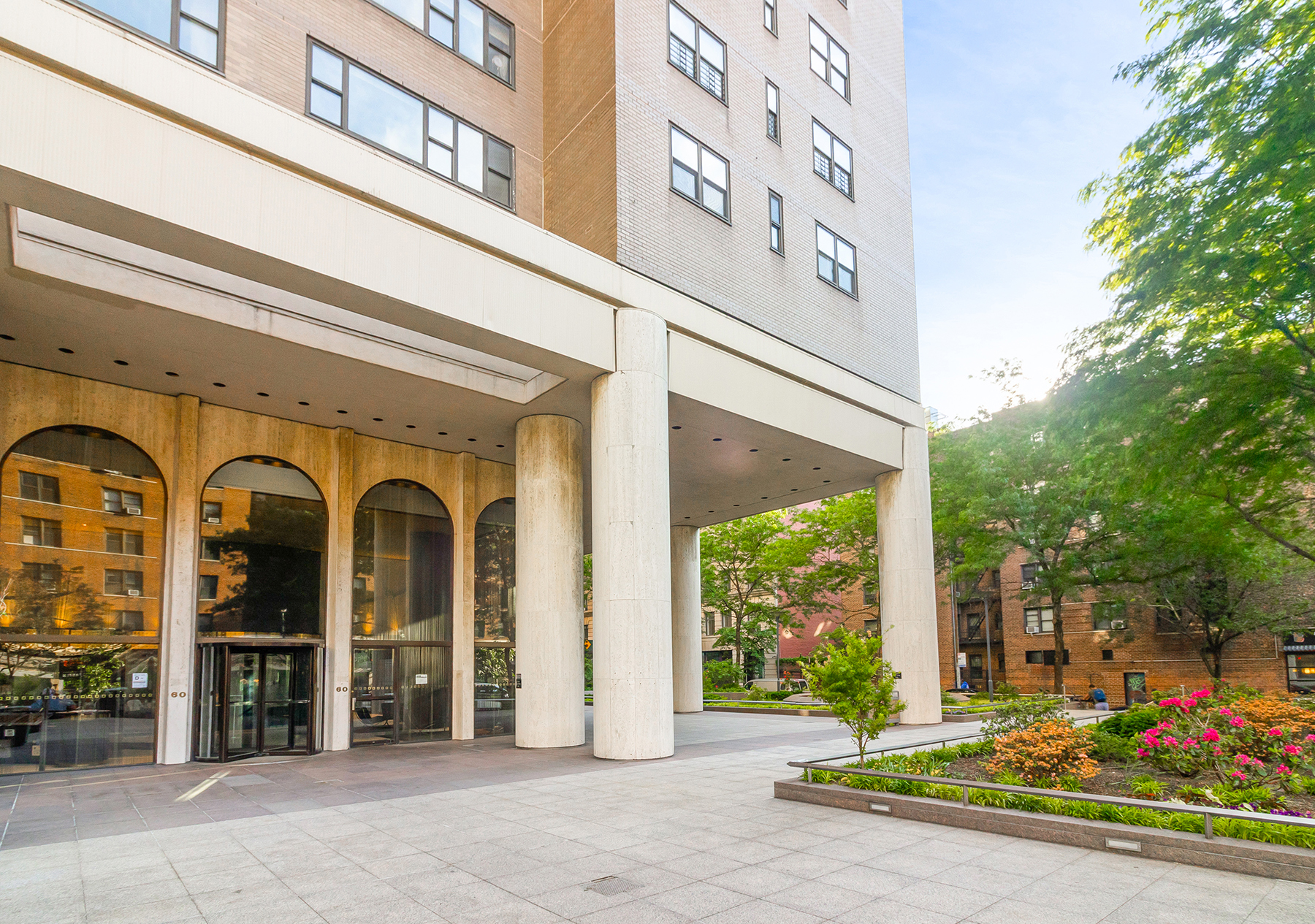 60 East 8th Street, Unit 24J Manhattan, NY 10003 - Photo 10 of 16 a front view of a building with street view
