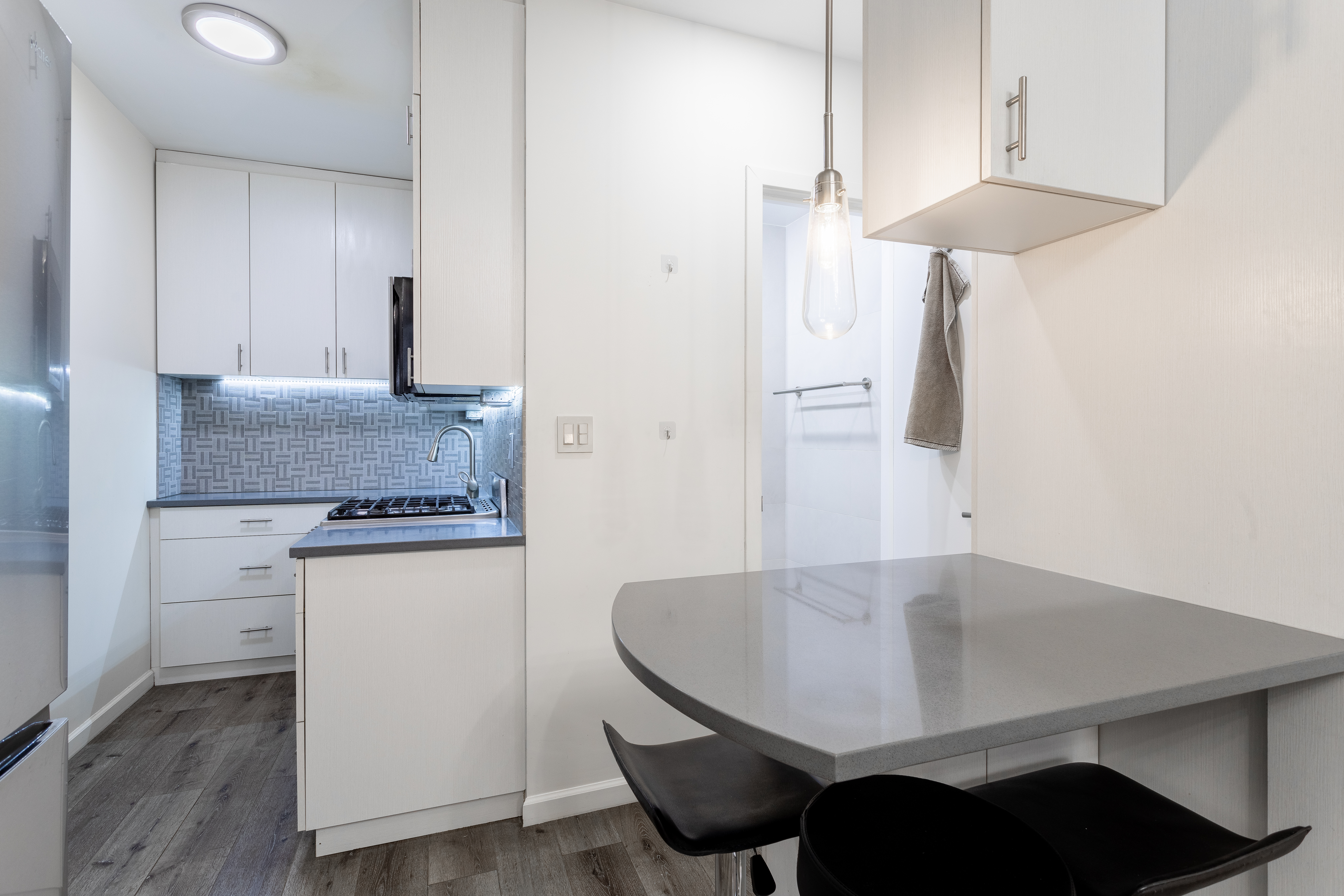 130 West 71st Street, Unit 1 Manhattan, NY 10023 - Photo 8 of 11 a kitchen with a table chairs and a stove top oven