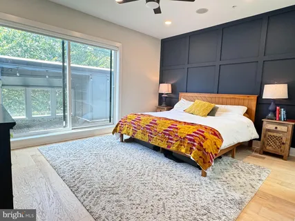 a bedroom with a bed and large window