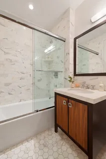 a bathroom with a sink mirror and a bathtub
