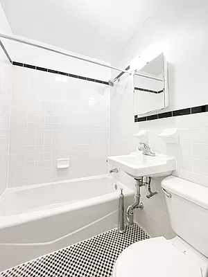 1734 2nd Avenue, Unit 1D Manhattan, NY 10128 - Photo 5 of 5 a bathroom with a sink a toilet and a bathtub