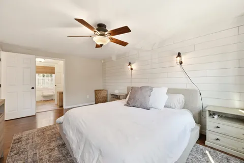 a bedroom with a bed and wooden floor