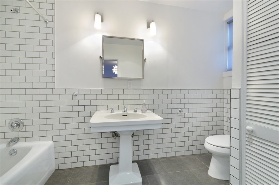 383 Grand Avenue Brooklyn, NY 11238 - Photo 29 of 32 a bathroom with a sink a toilet and mirror