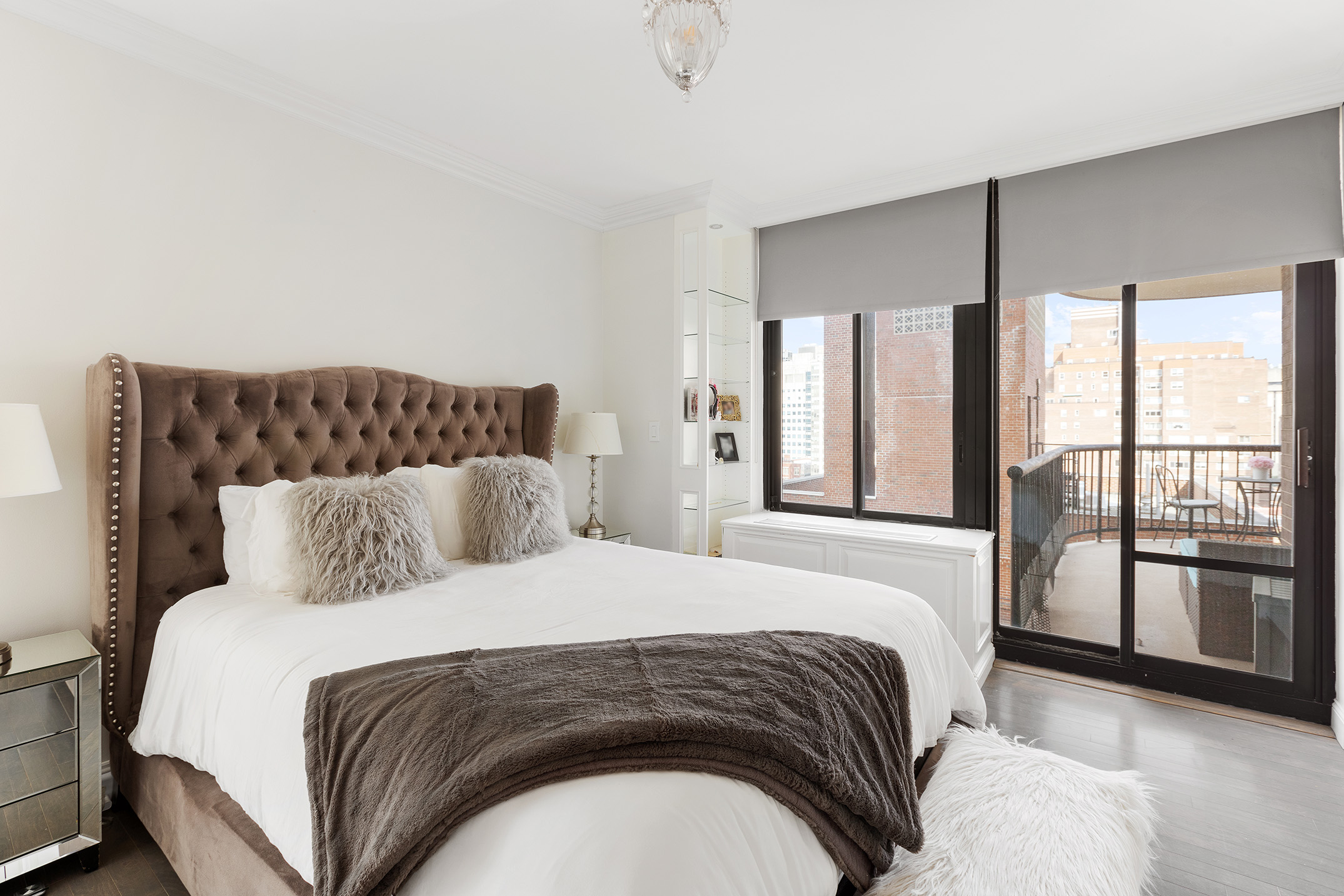 304 East 65th Street, Unit 14D Manhattan, NY 10065 - Photo 4 of 14 a bedroom with a large bed and a large window