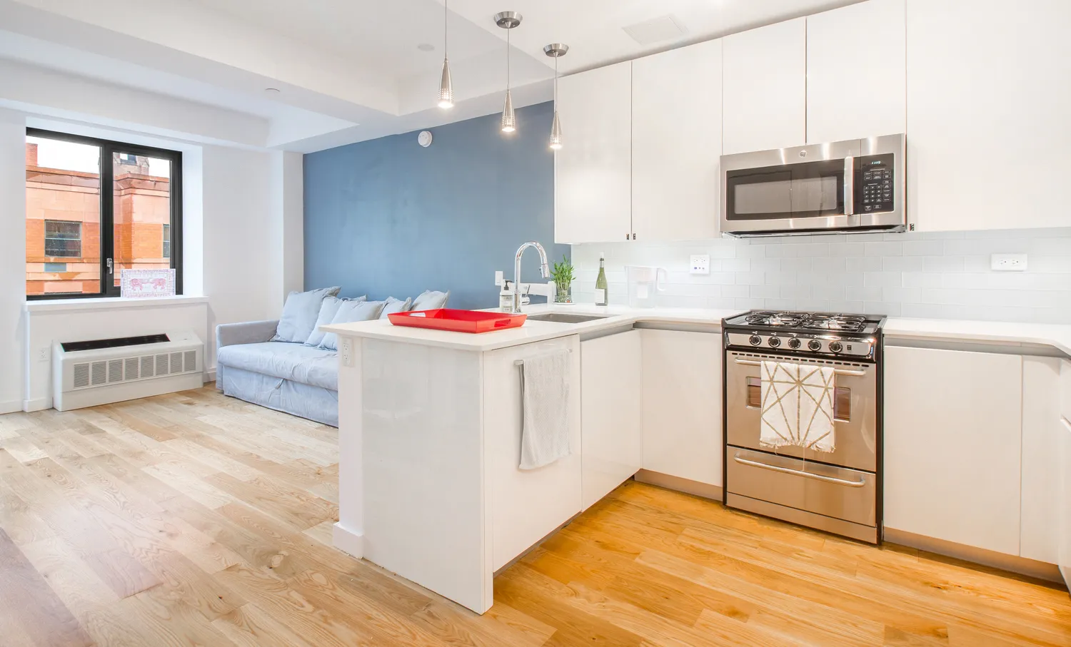 a kitchen with a sink stove and white cabinets