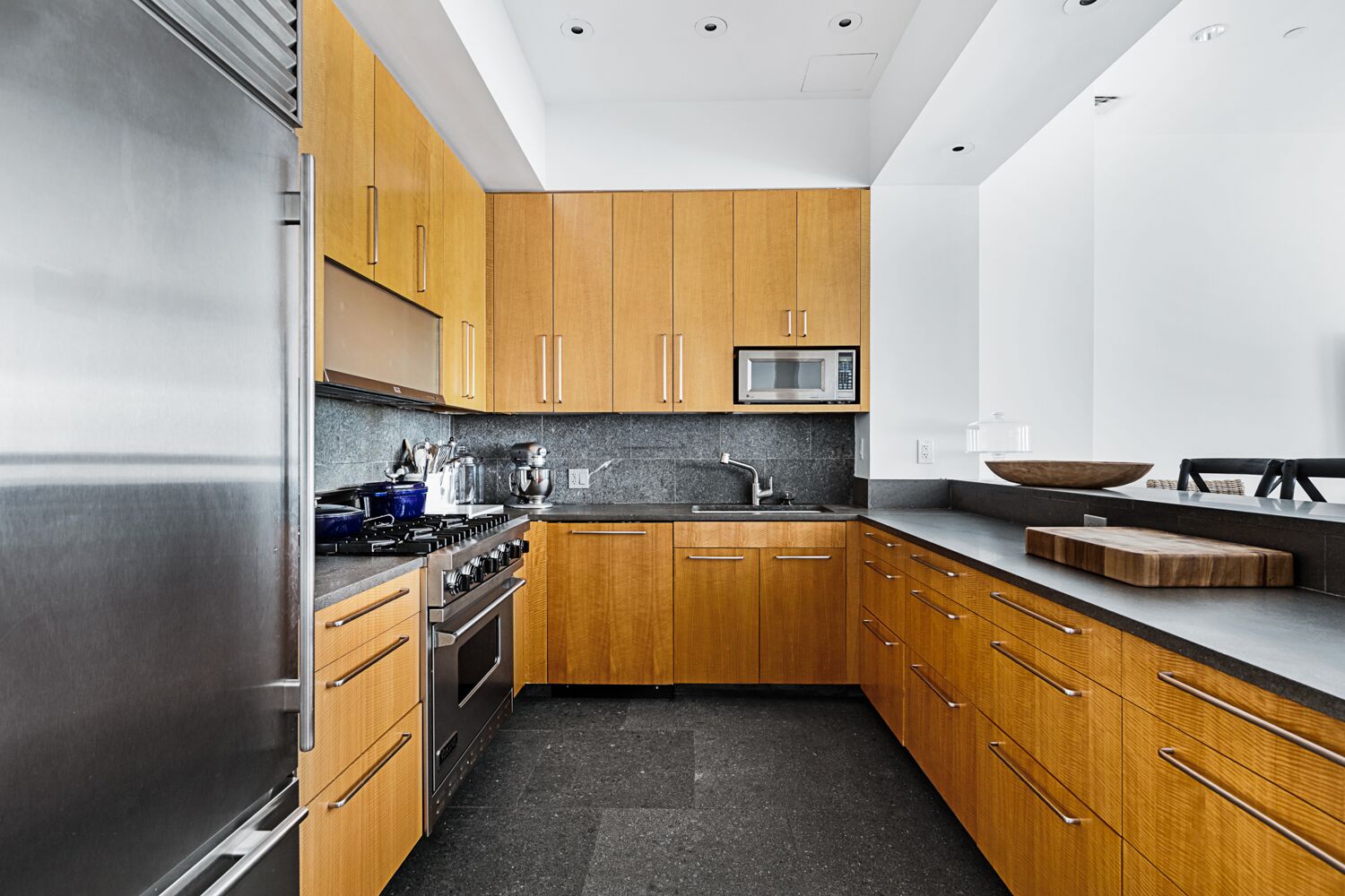 52 Thomas Street, Unit 2B Manhattan, NY 10013 - Photo 4 of 9 a kitchen with stainless steel appliances granite countertop a sink and cabinets