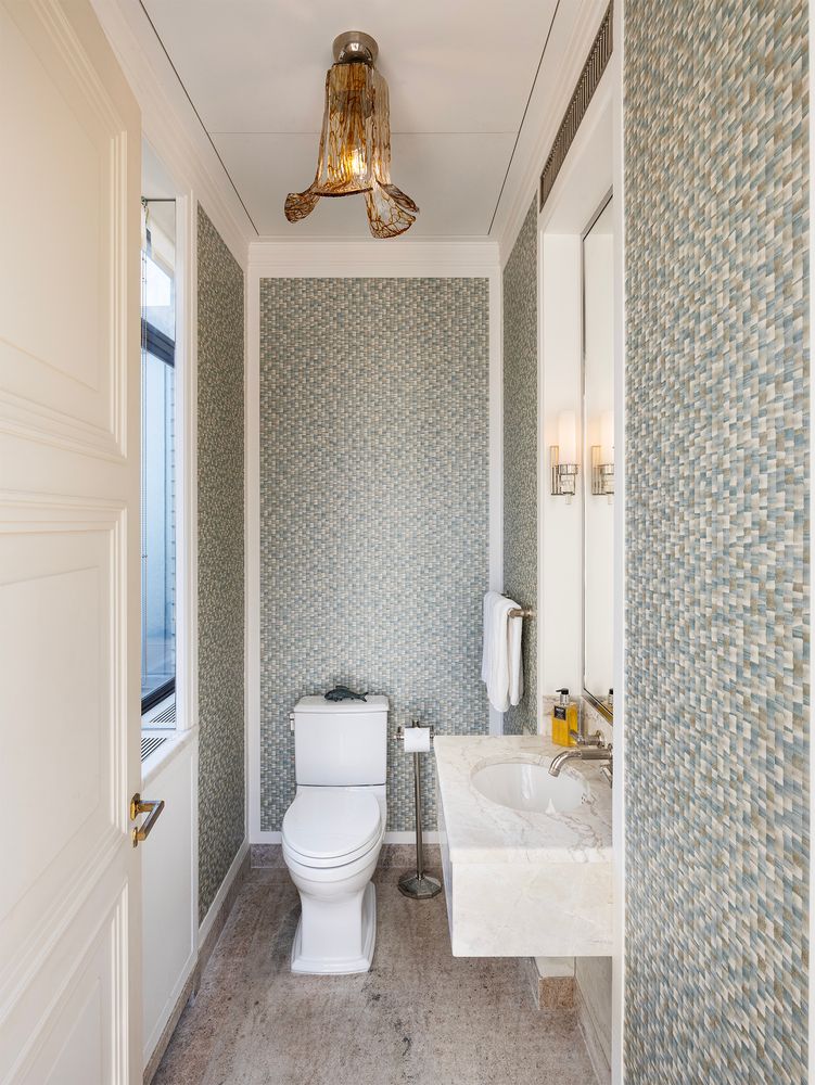 a white toilet sitting next to a bathroom sink