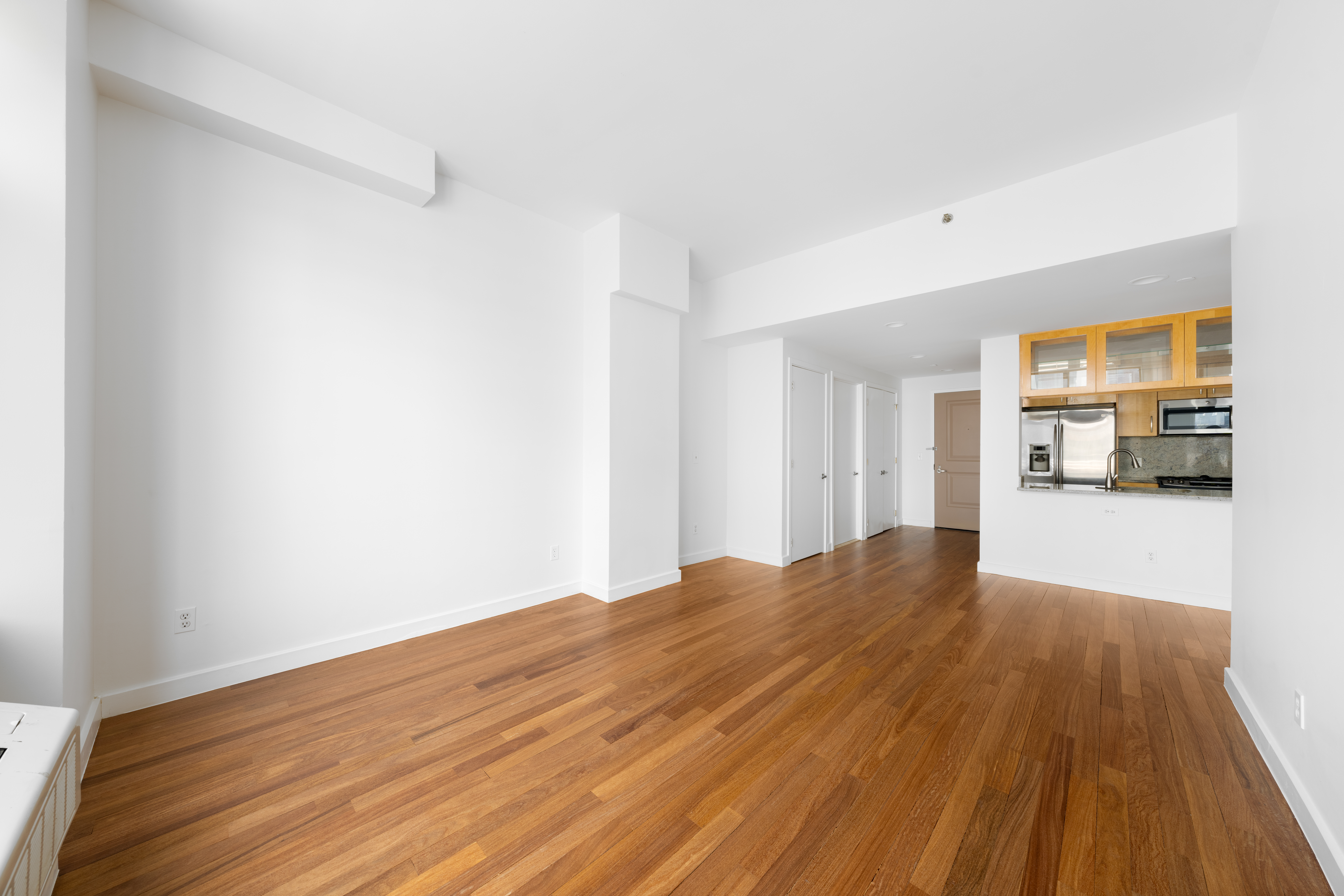 161 East 110th Street, Unit 6A Manhattan, NY 10029 - Photo 3 of 10 a view of empty room with wooden floor