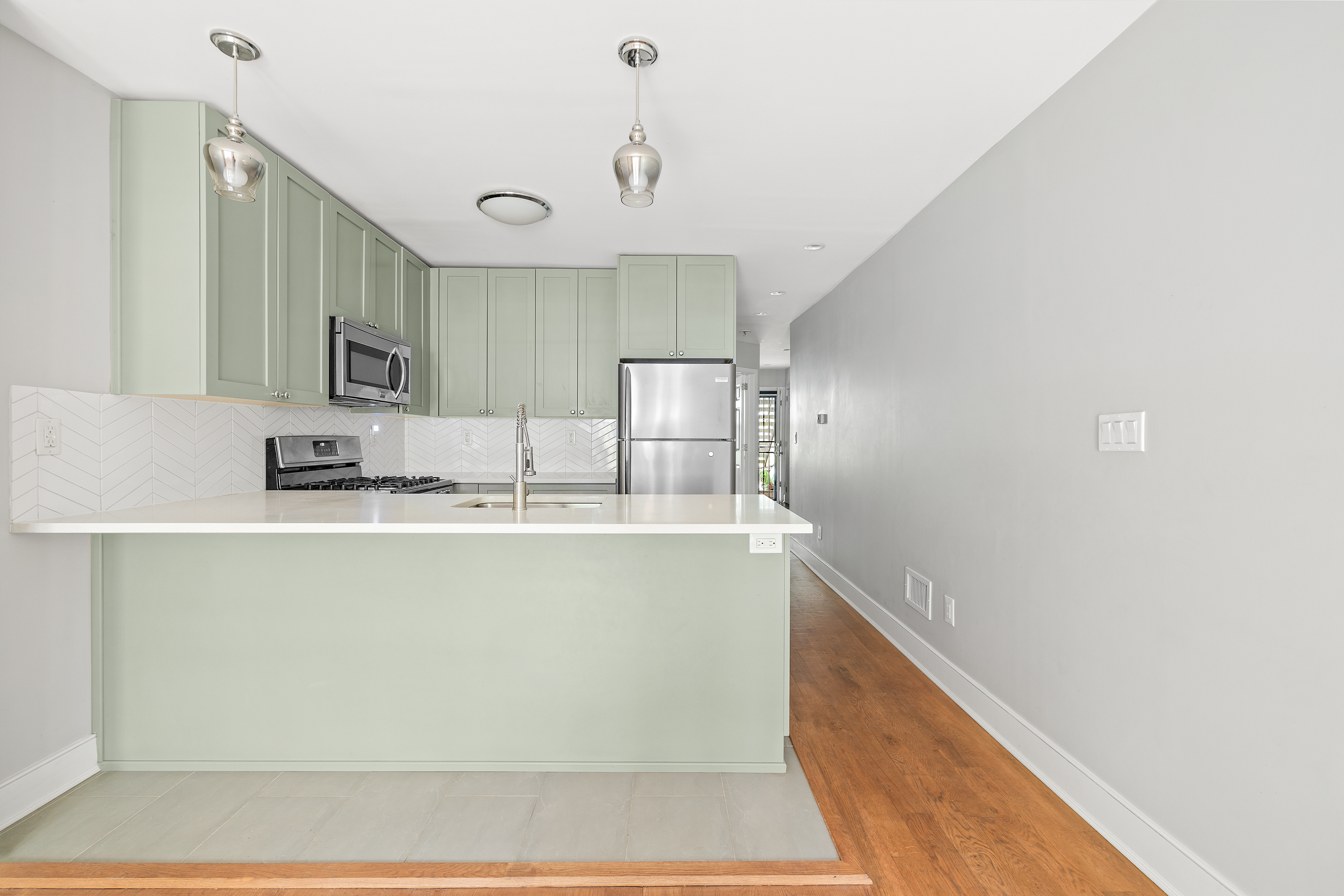 272 Prospect Place, Unit GARDEN Brooklyn, NY 11238 - Photo 3 of 8 a kitchen with stainless steel appliances granite countertop a sink and a refrigerator