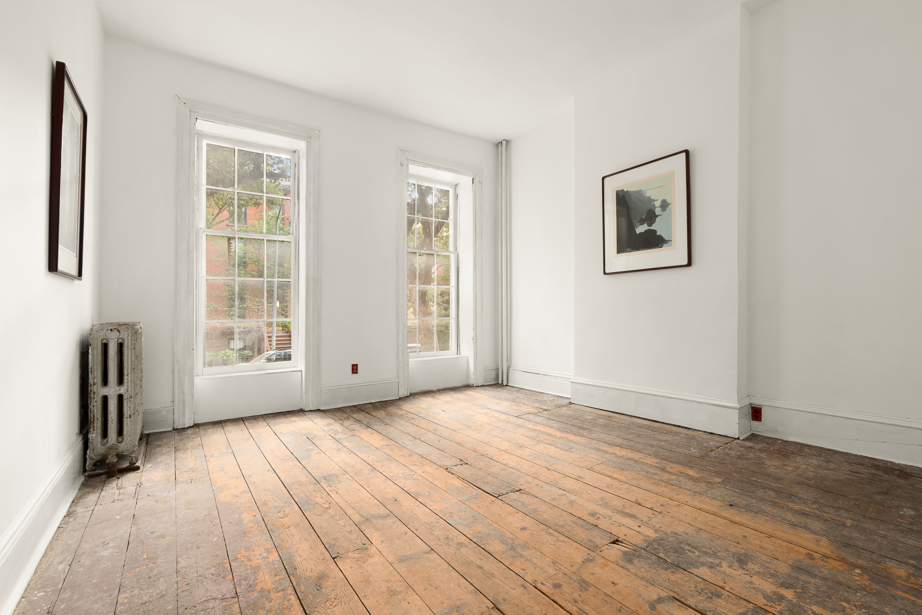 217 Dean Street Brooklyn, NY 11217 - Photo 3 of 26 a view of empty room with wooden floor and fan