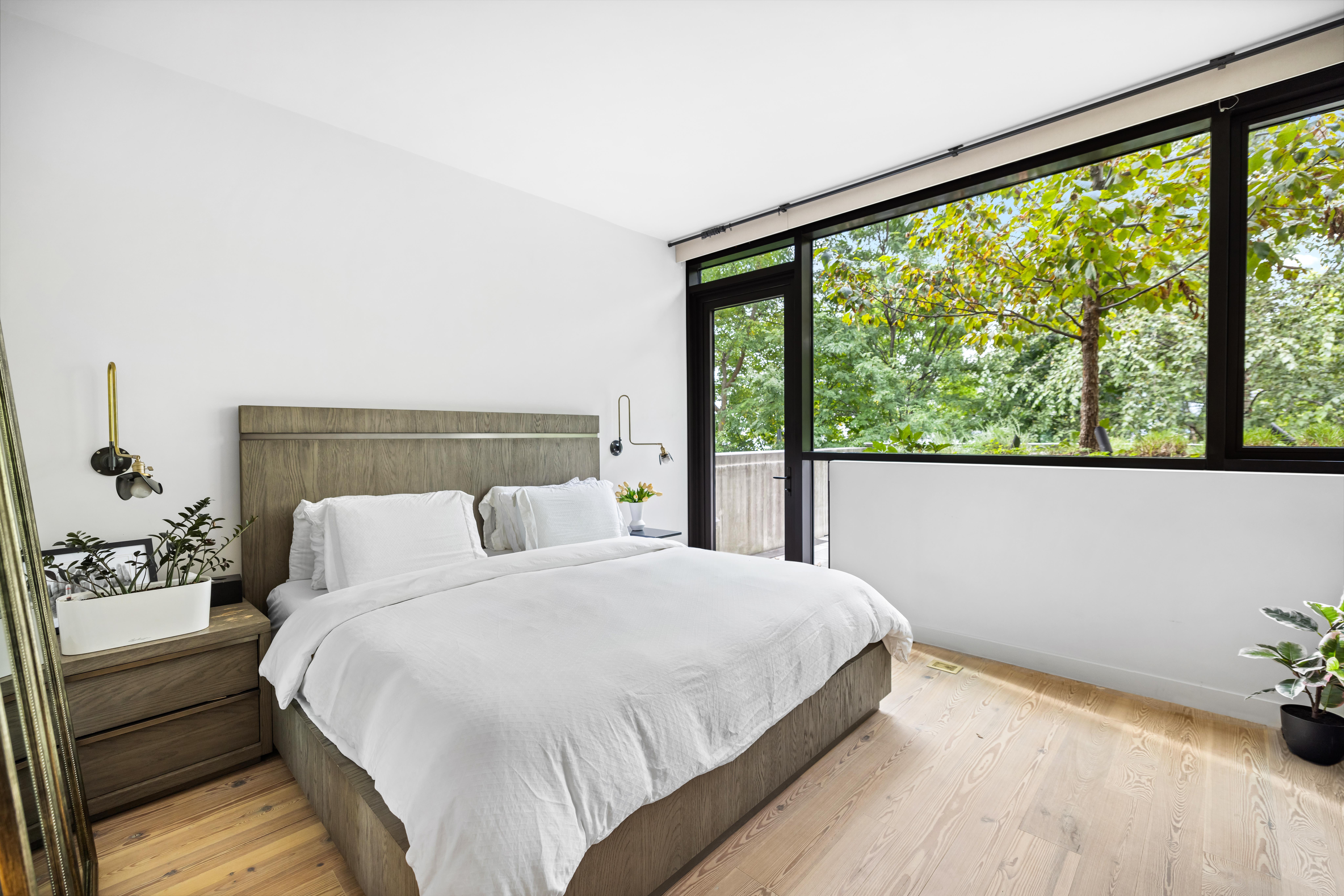130 Furman Street, Unit S102 Brooklyn, NY 11201 - Photo 8 of 26 a bedroom with a large bed and a large window