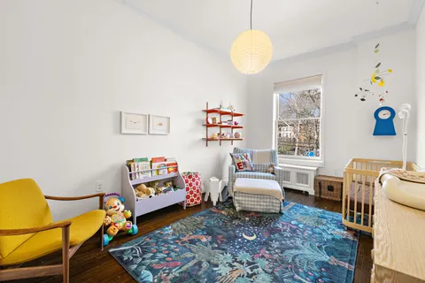 a bedroom with furniture and a window