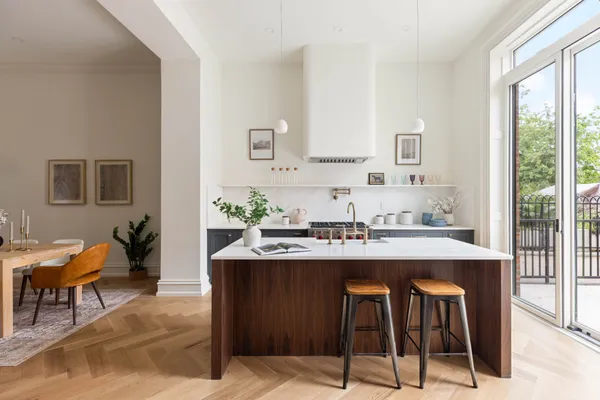 a view of kitchen with sink table and chairs