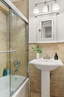 a bathroom with a sink a mirror and a bathtub