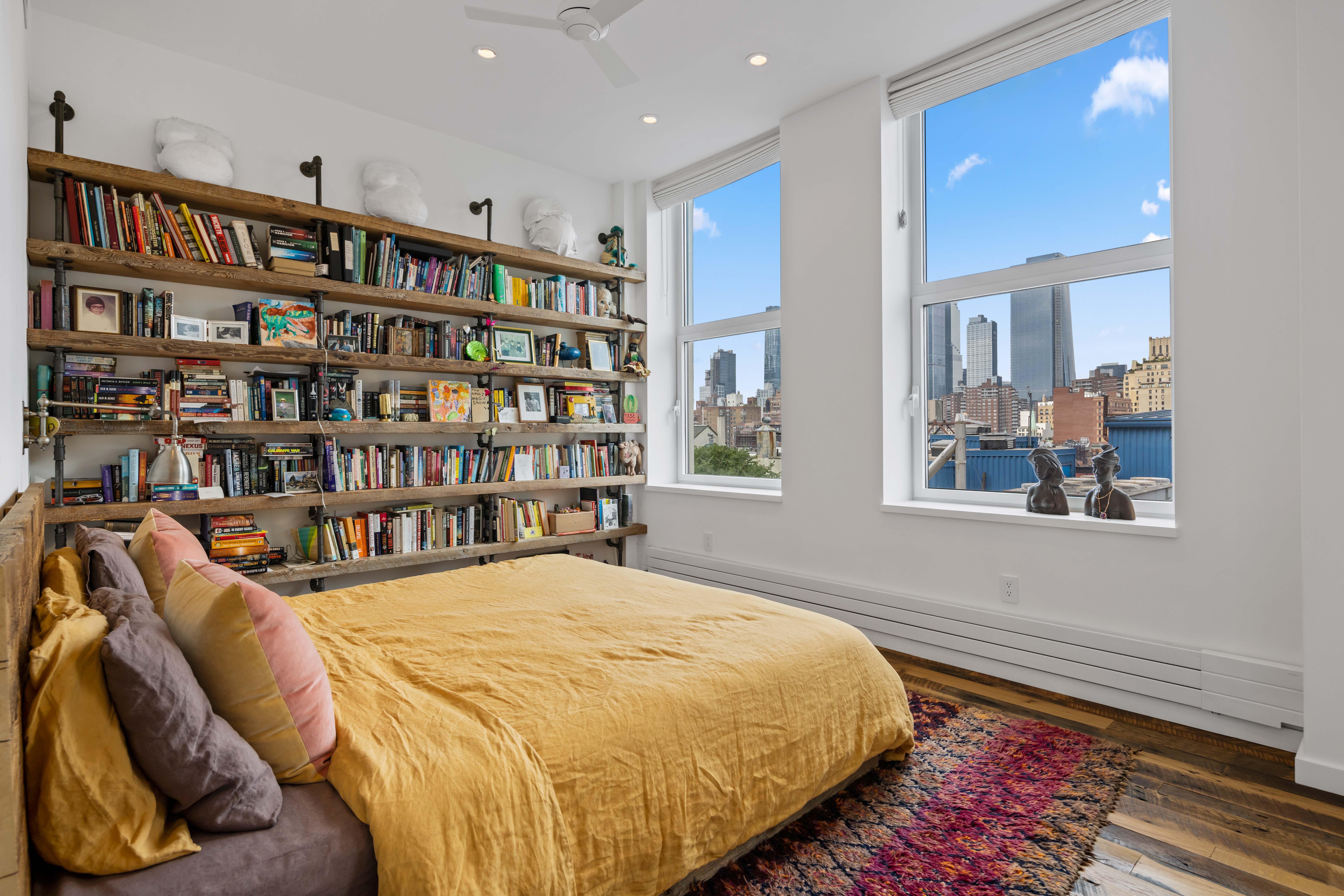 257 West 17th Street, Unit 7AB Manhattan, NY 10011 - Photo 11 of 21 a spacious bedroom with a bed and a book shelf