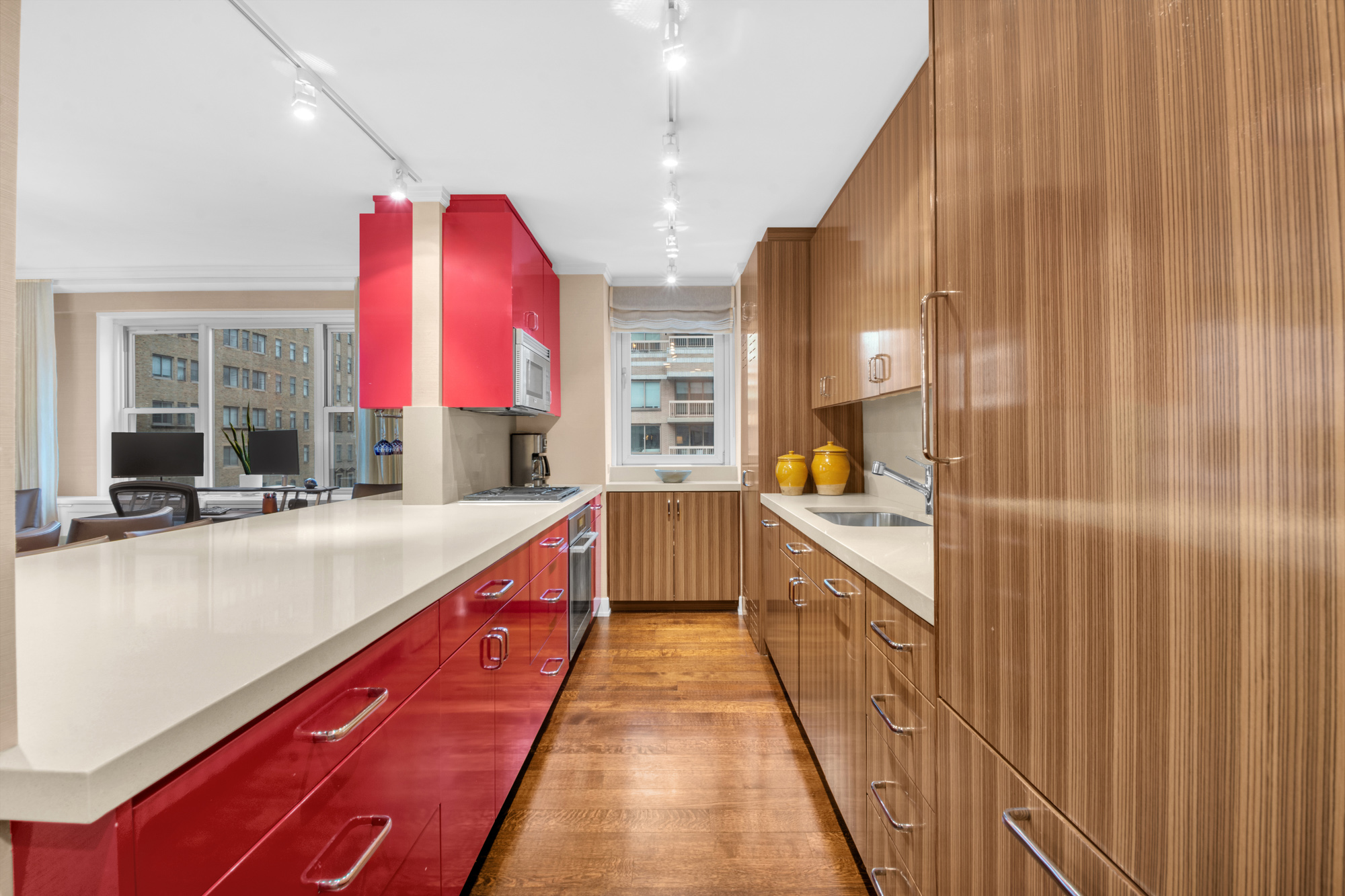 150 East 69th Street, Unit 6Q Manhattan, NY 10021 - Photo 7 of 15 a large kitchen with stainless steel appliances granite countertop a sink and cabinets
