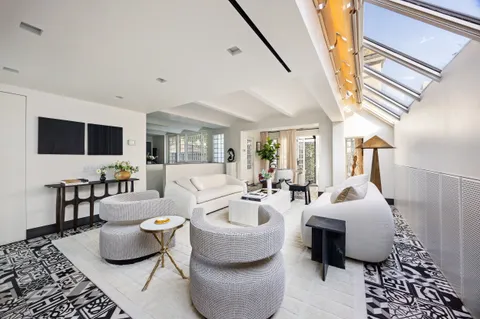 a living room with furniture and a rug