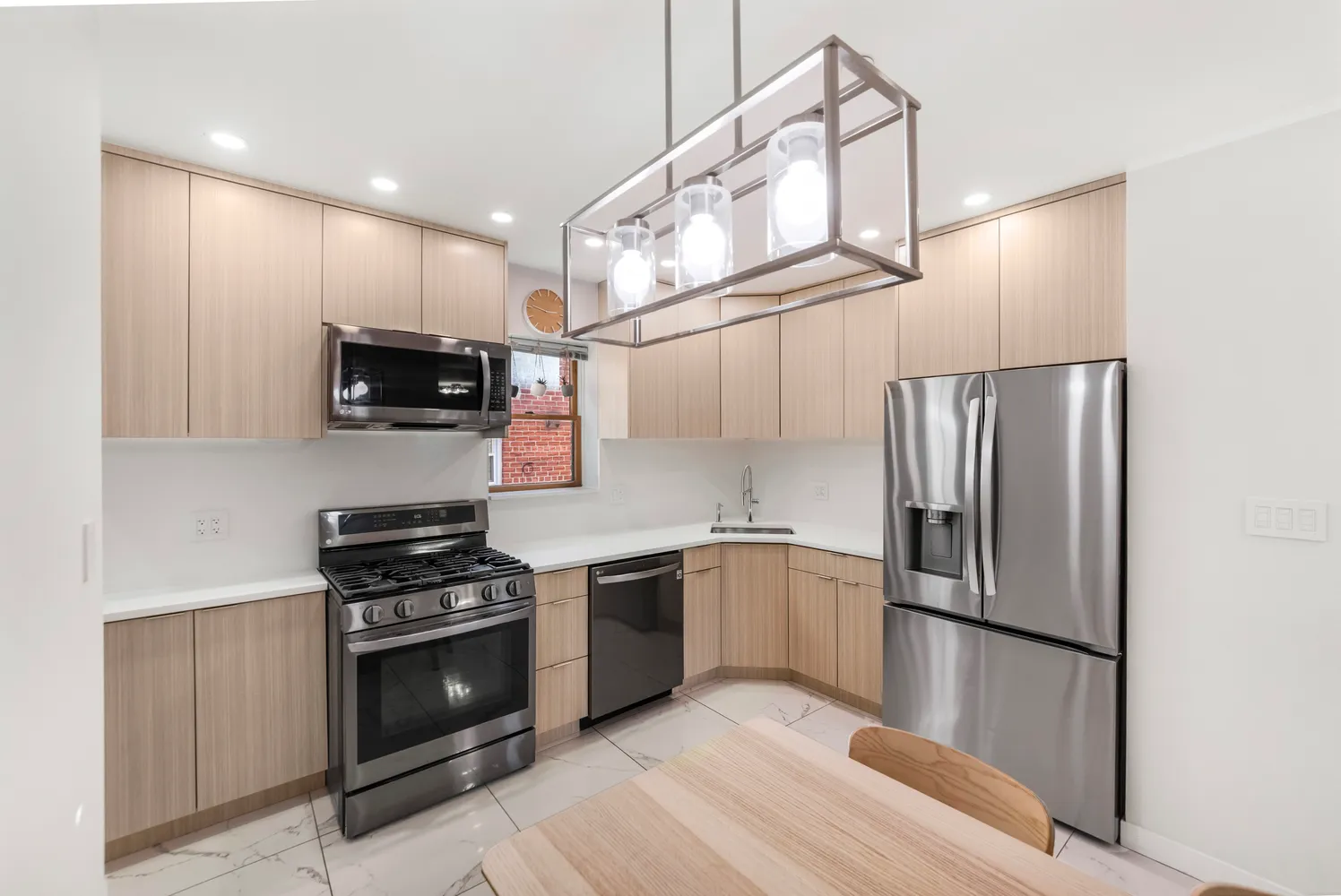 a kitchen with stainless steel appliances a refrigerator stove and microwave