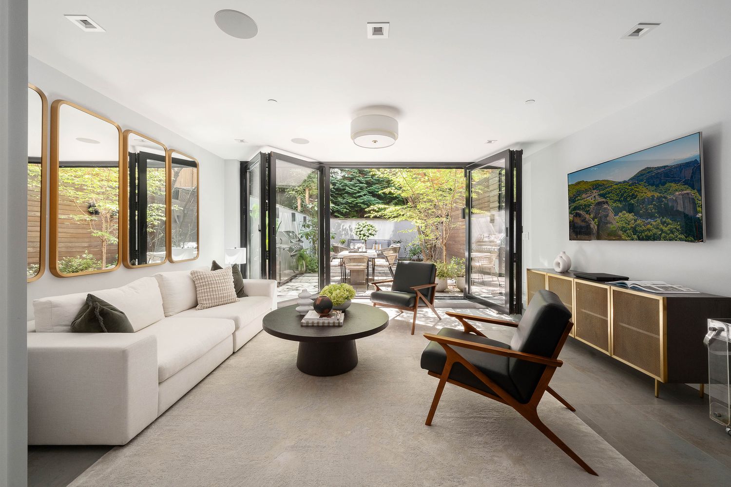 520 East 89th Street Manhattan, NY 10128 - Photo 2 of 40 a living room with furniture and a flat screen tv
