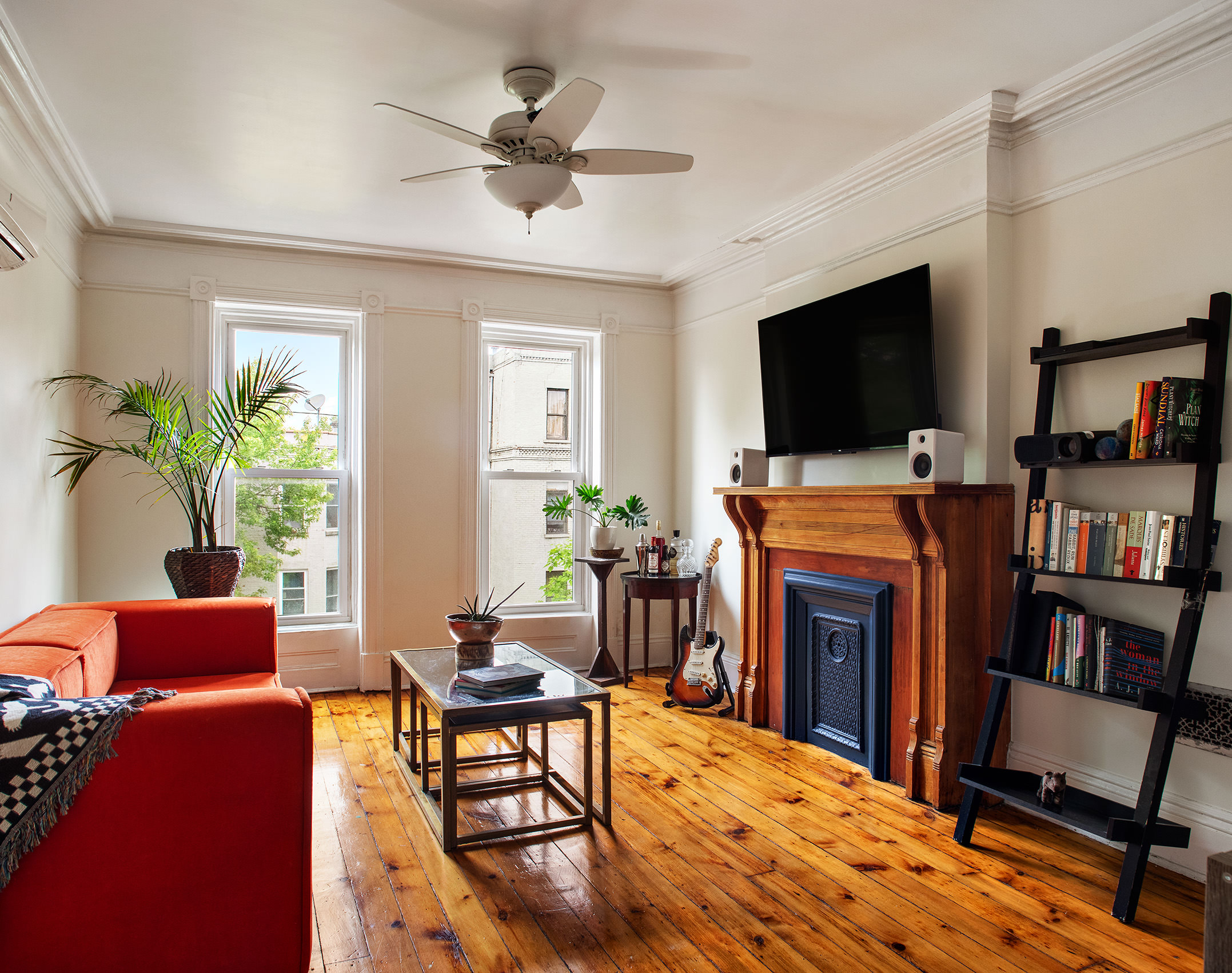 183 Halsey Street Brooklyn, NY 11216 - Photo 12 of 23 a living room with furniture a flat screen tv and a fireplace