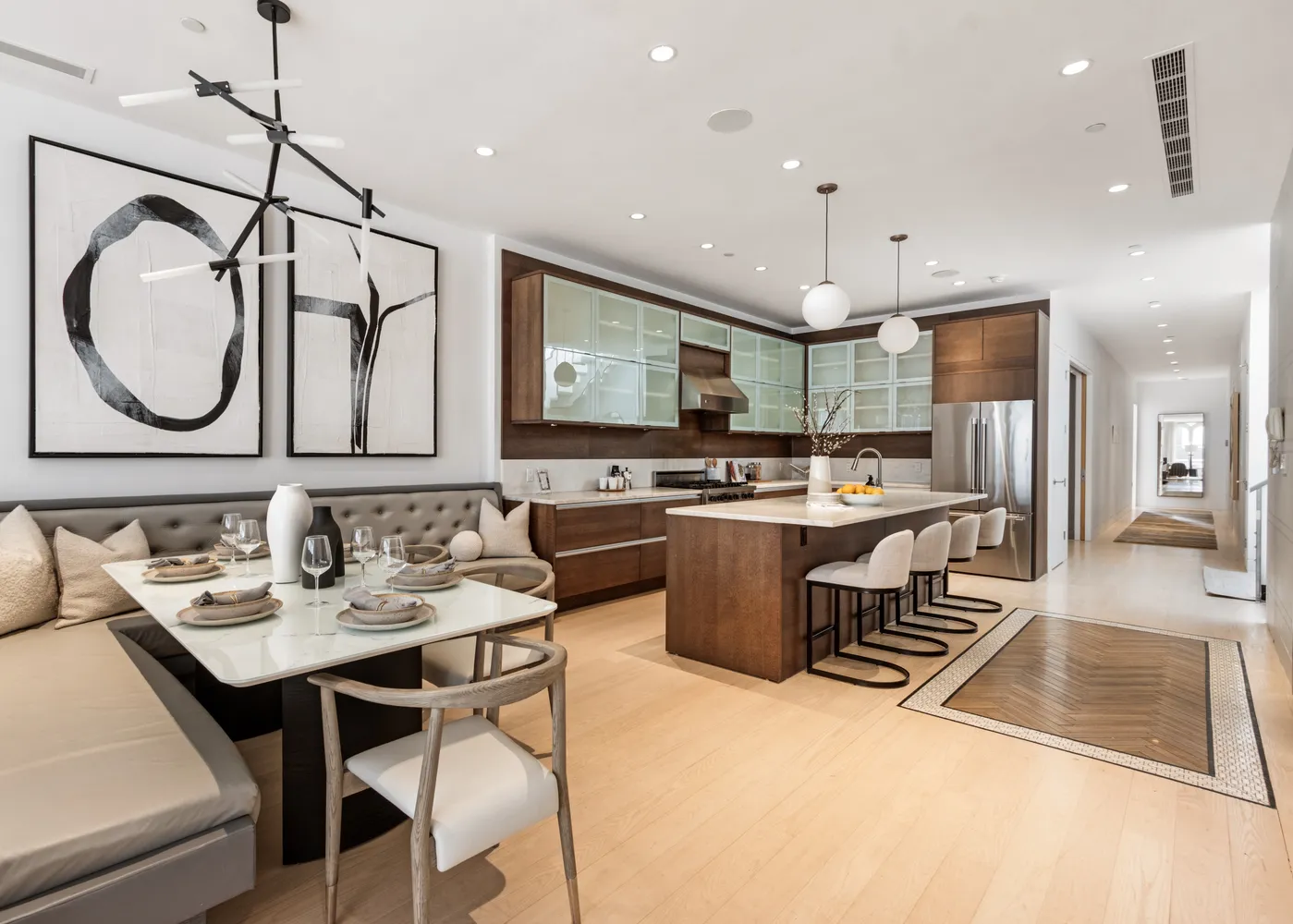 a kitchen with kitchen island granite countertop a sink a counter top space stainless steel appliances and cabinets