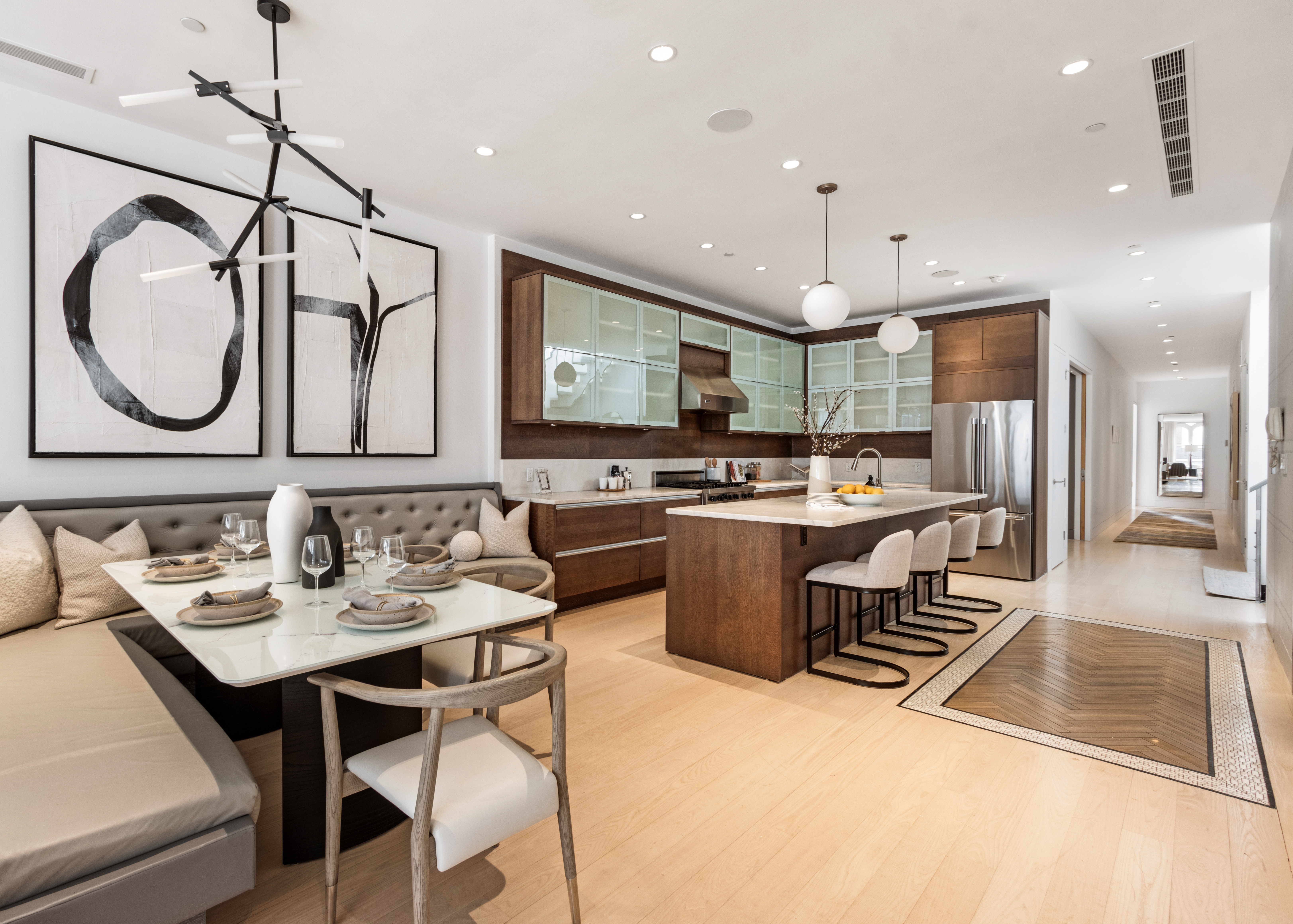 85 Leonard Street, Unit PH Manhattan, NY 10013 - Photo 7 of 27 a kitchen with kitchen island granite countertop a sink a counter top space stainless steel appliances and cabinets