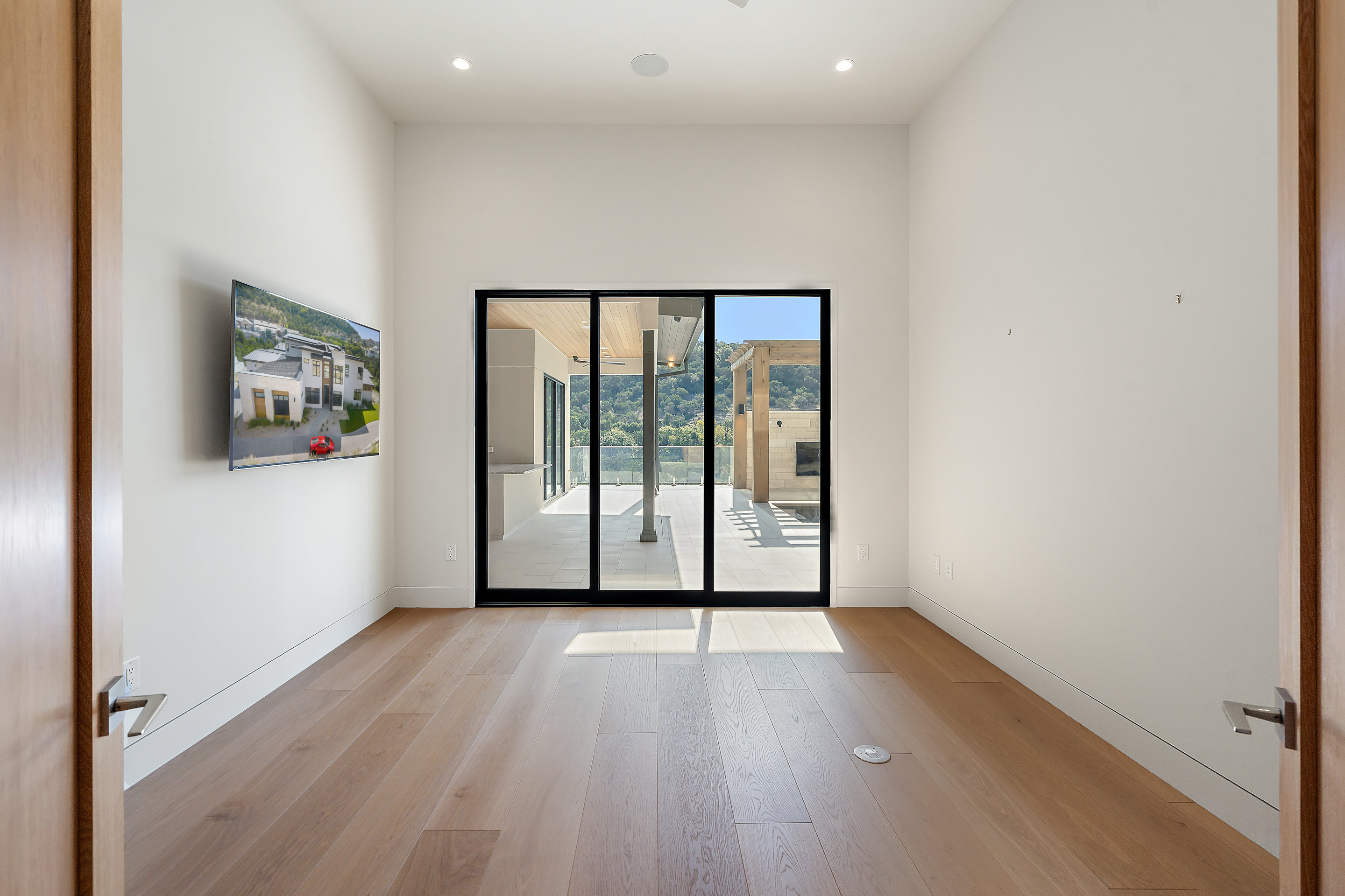 1905 Hallam Drive Austin, TX 78746 - Photo 15 of 39 a view of a big room with wooden floor and windows