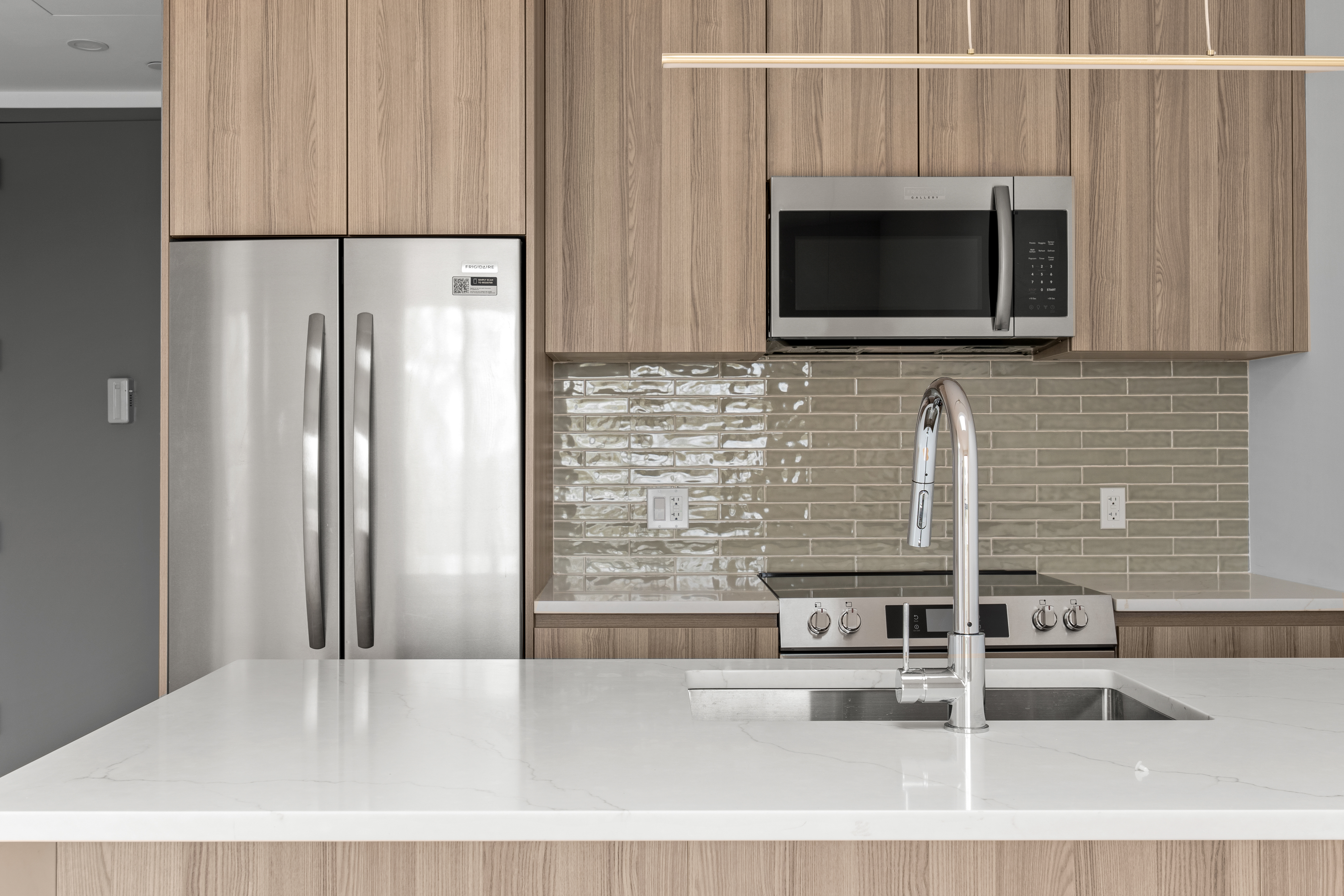 82 Cooper Street, Unit 3A Brooklyn, NY 11207 - Photo 8 of 17 a kitchen with granite countertop a microwave a stove and a refrigerator