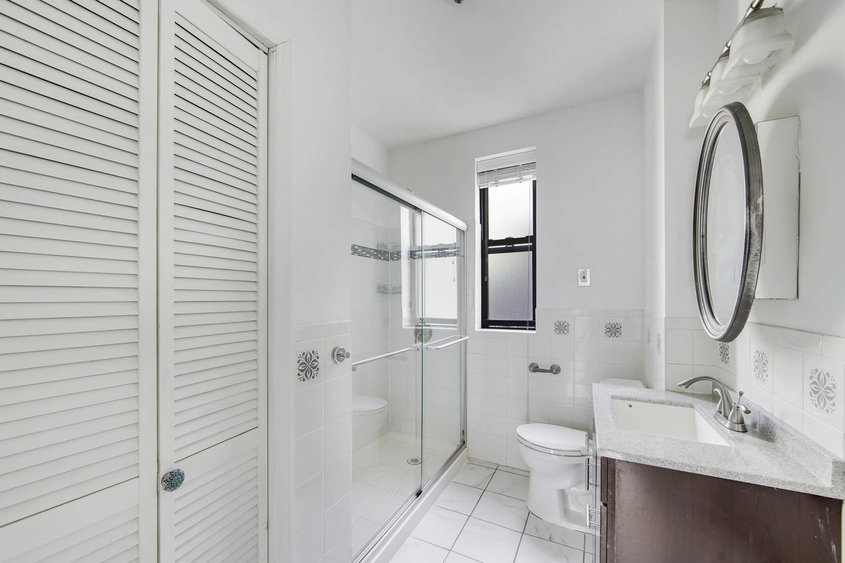 7825 4th Avenue, Unit E10 Brooklyn, NY 11209 - Photo 5 of 8 a bathroom with a toilet sink and shower