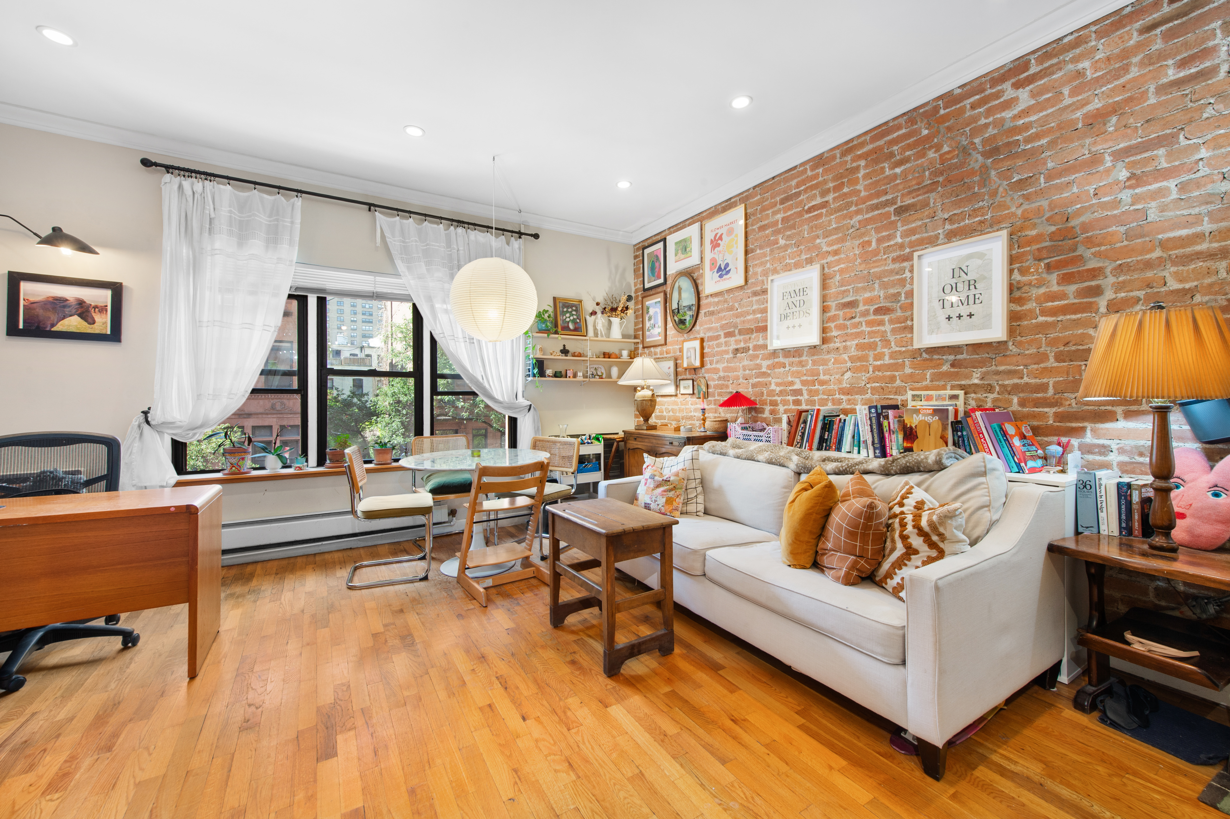261 West 71st Street, Unit 8 Manhattan, NY 10023 - Photo 3 of 15 a living room with furniture and a large window