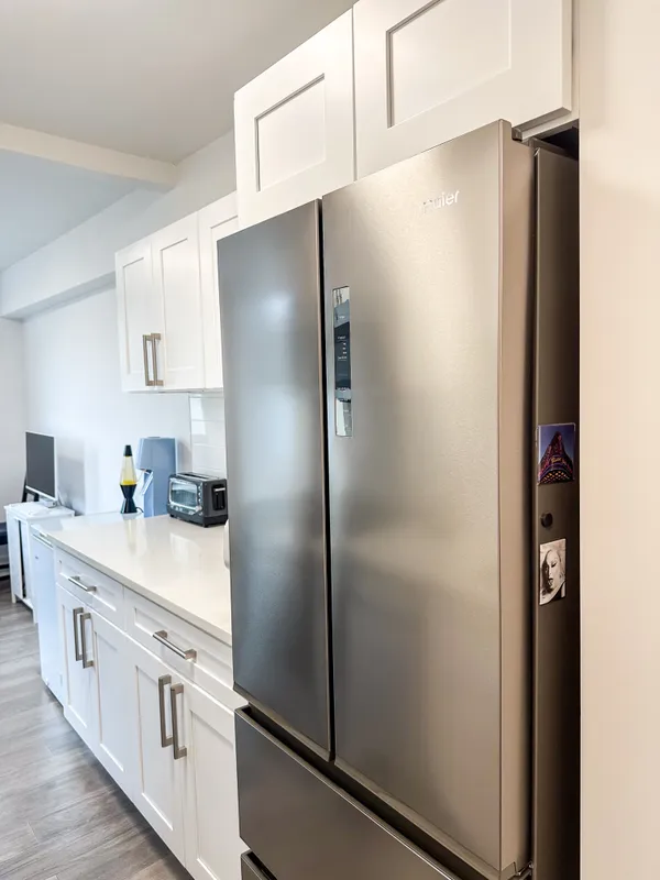 a kitchen with stainless steel appliances a refrigerator and a sink