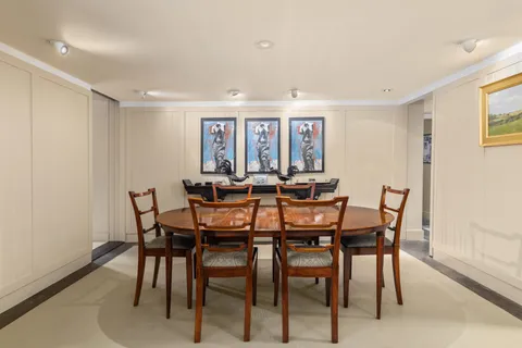 a view of a dining room with furniture and a potted plant