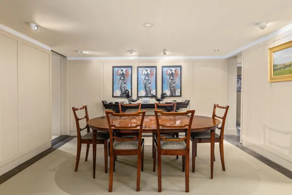 a view of a dining room with furniture and a potted plant