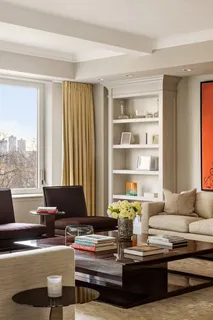 a living room with furniture and large window