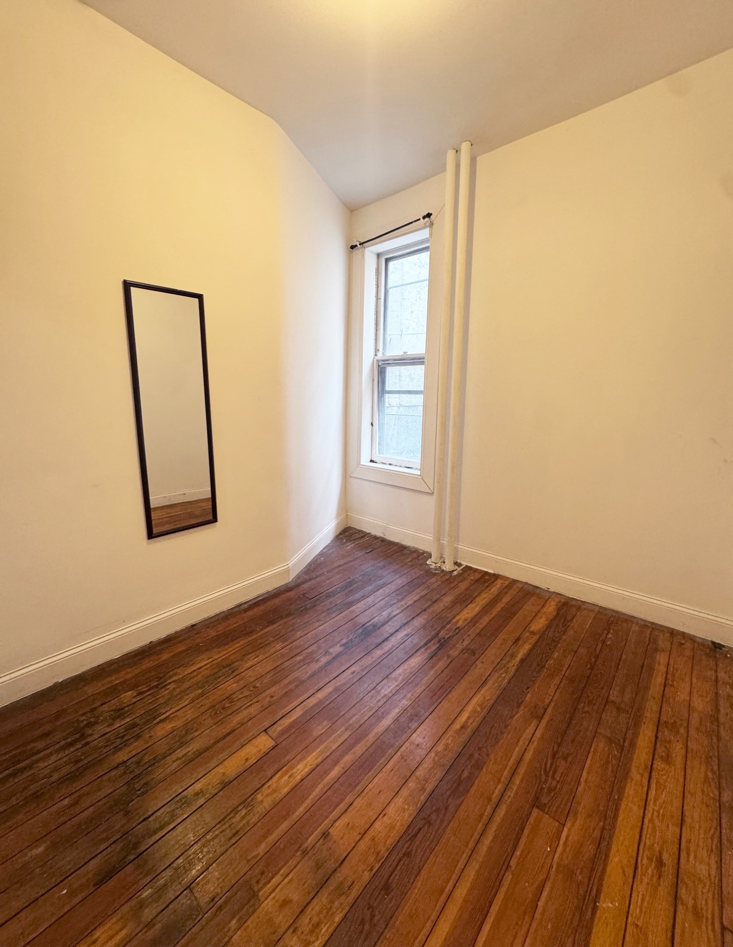 562 7th Street, Unit 3 Brooklyn, NY 11215 - Photo 4 of 6 an empty room with wooden floor and windows