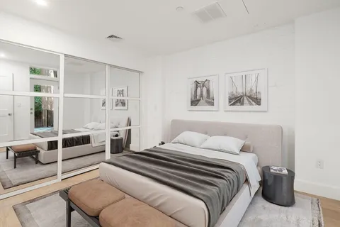 a bedroom with a bed and the view of living room