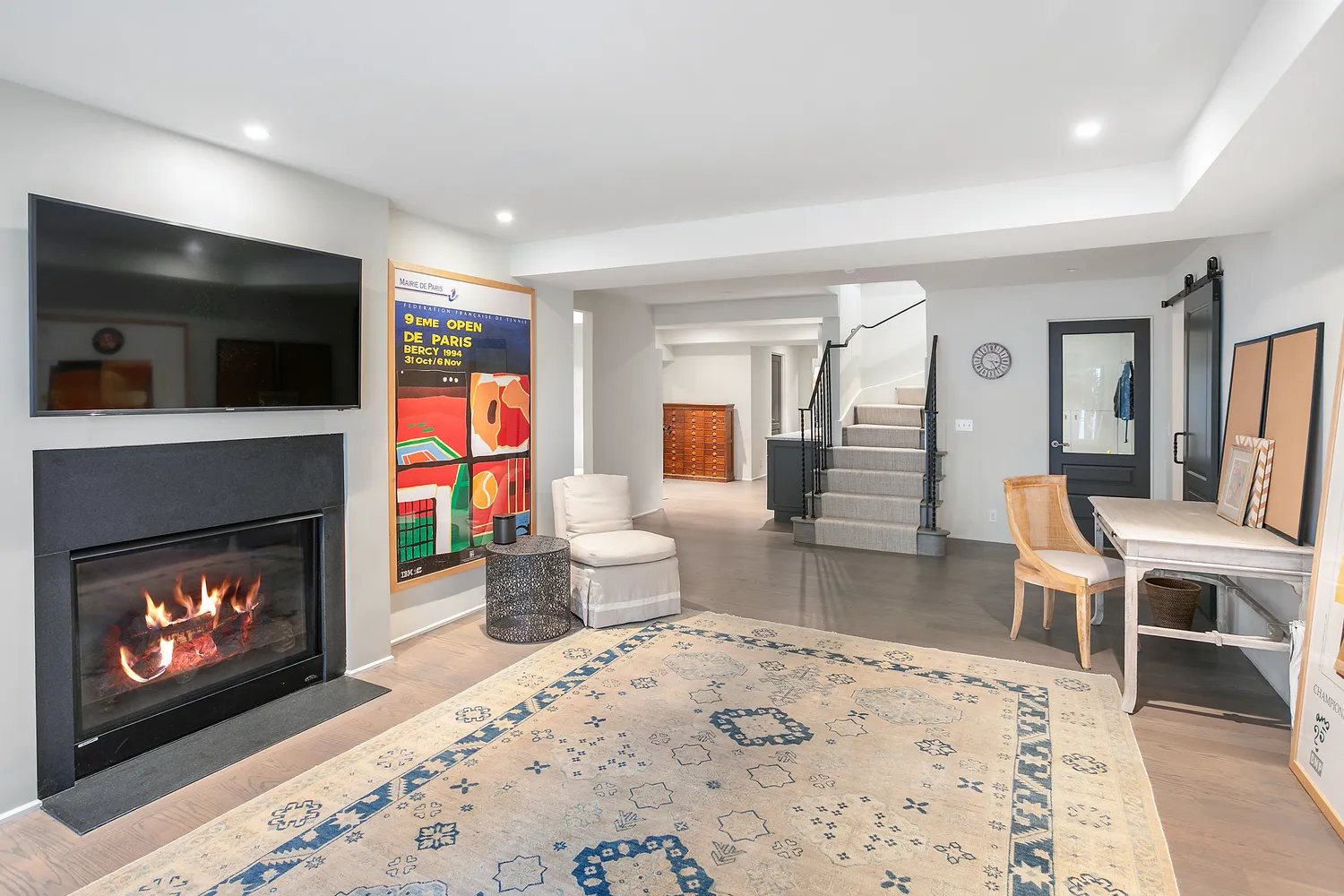 a living room with furniture a flat screen tv and a fireplace
