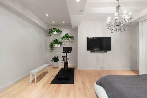 a living room with a flat screen tv and a chandelier