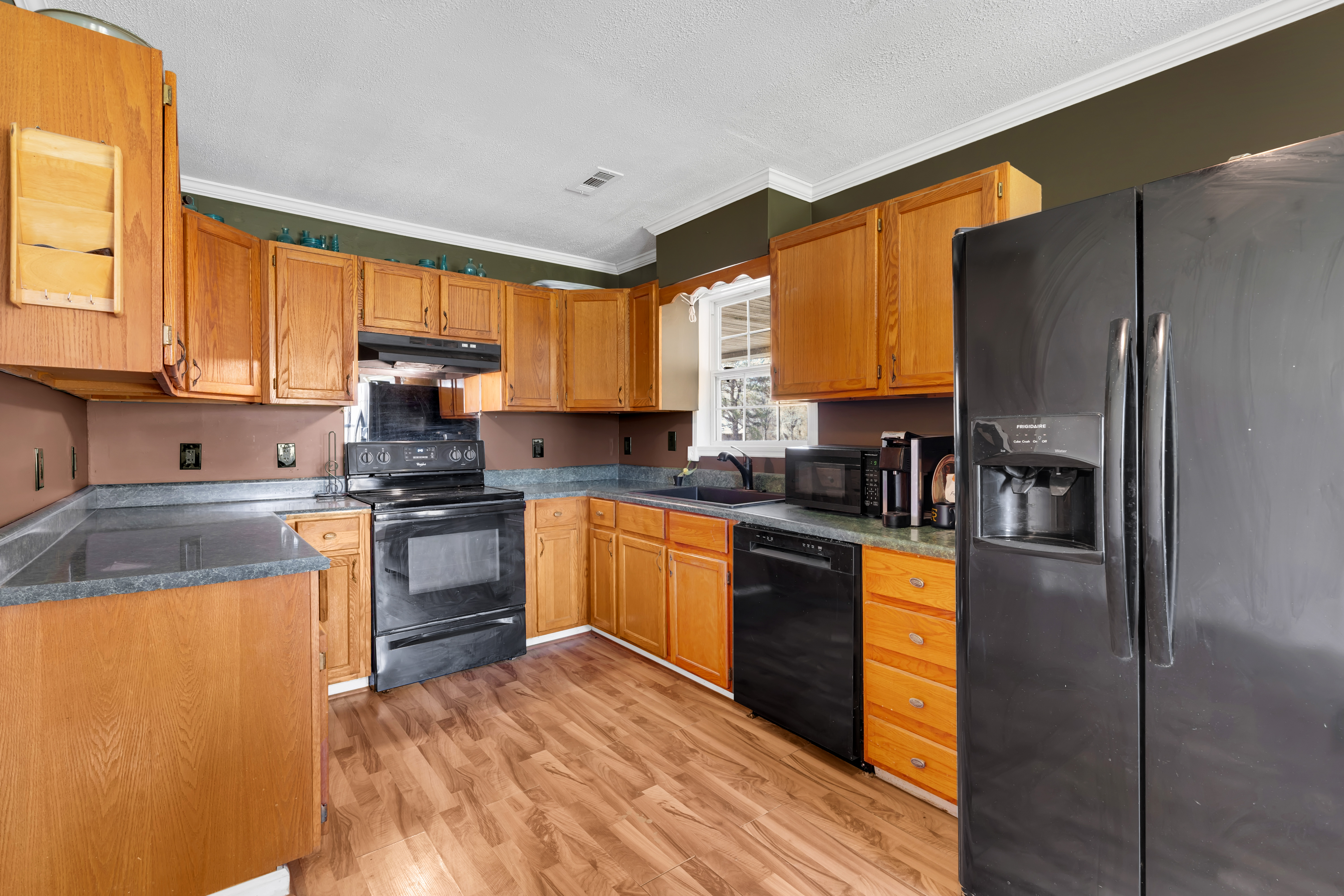 2073 Harpo Road Manchester, TN 37355 - Photo 34 of 45 a kitchen with granite countertop a refrigerator stove top oven and sink