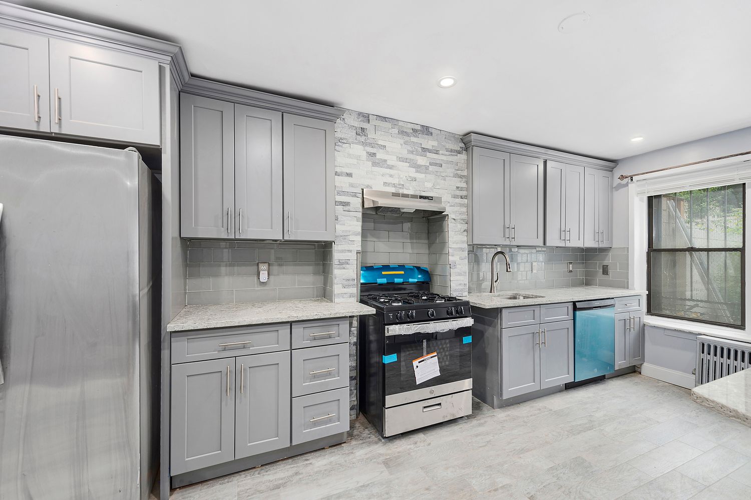 a kitchen with stainless steel appliances granite countertop a refrigerator sink and stove