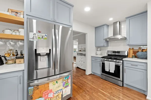 a kitchen with stainless steel appliances granite countertop a refrigerator stove and sink