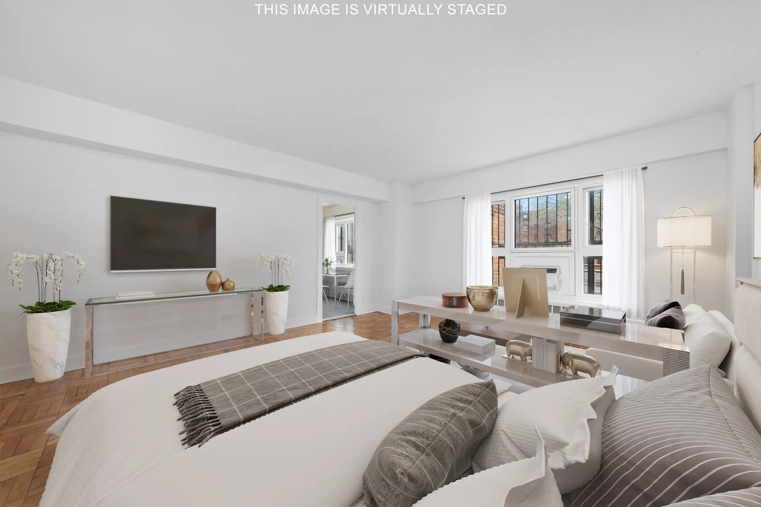 a bedroom with a bed and a flat screen television