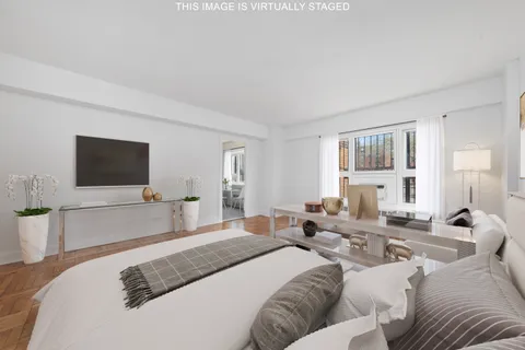 a bedroom with a bed and a flat screen television