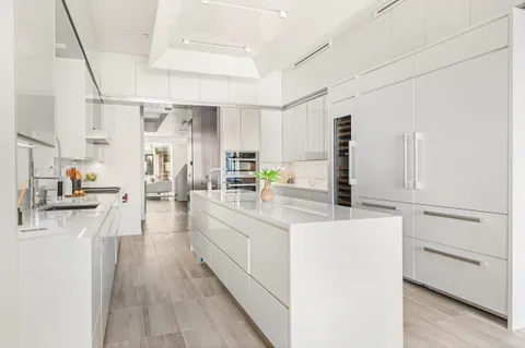 a kitchen with cabinets a sink and appliances