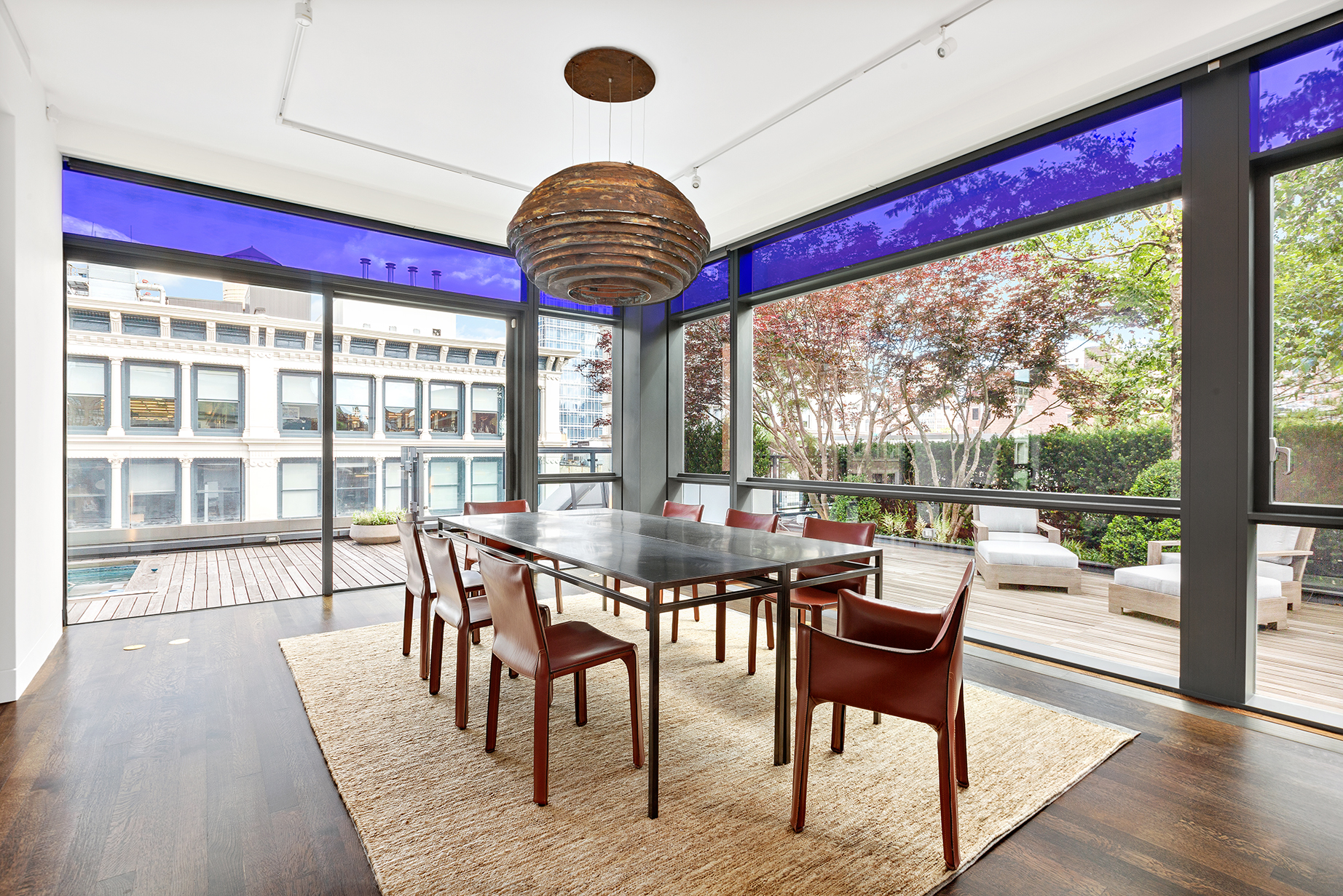 40 Mercer Street, Unit PH30 Manhattan, NY 10013 - Photo 6 of 20 a dining room with furniture a chandelier and wooden floor