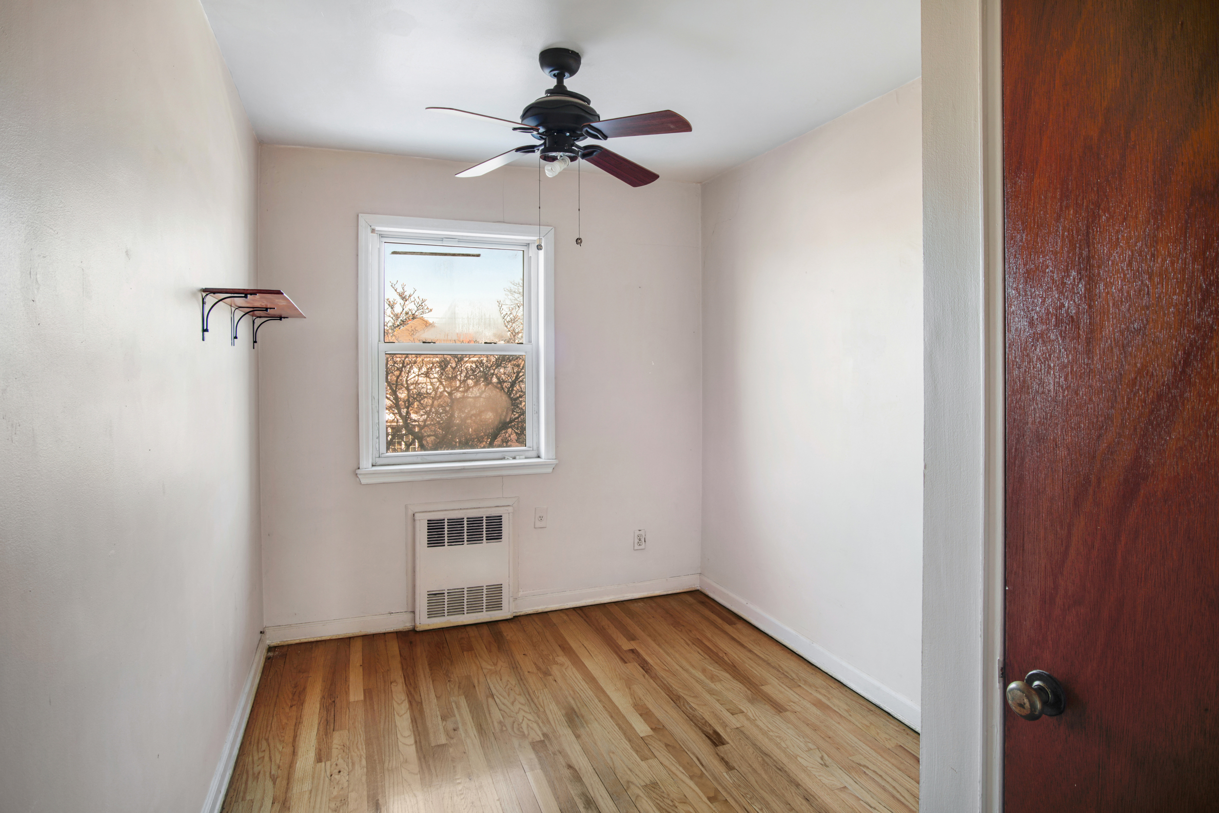 1986 West 13th Street Brooklyn, NY 11223 - Photo 5 of 11 a view of empty room with a window and wooden floor